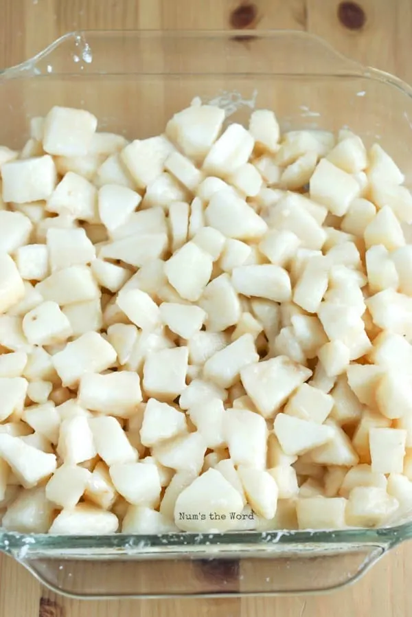 The Best Pear Crisp - fresh cut pears covered in corn starch in casserole dish