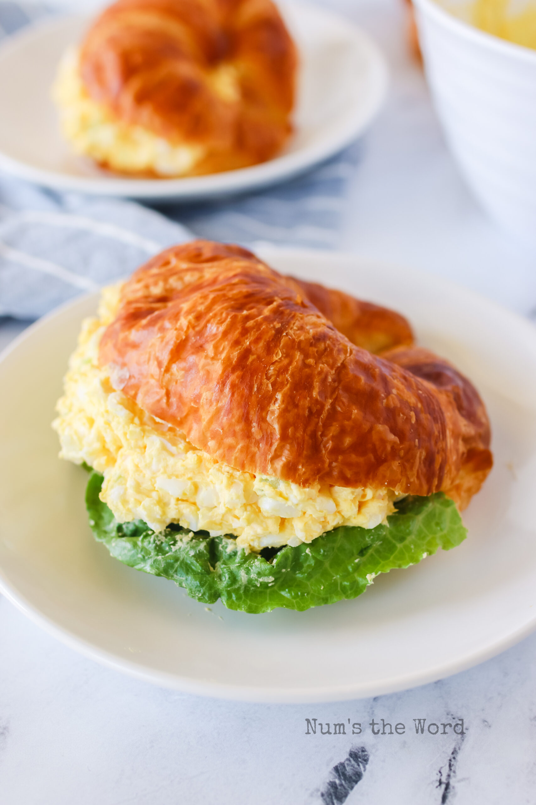 egg salad on a croissant with lettuce