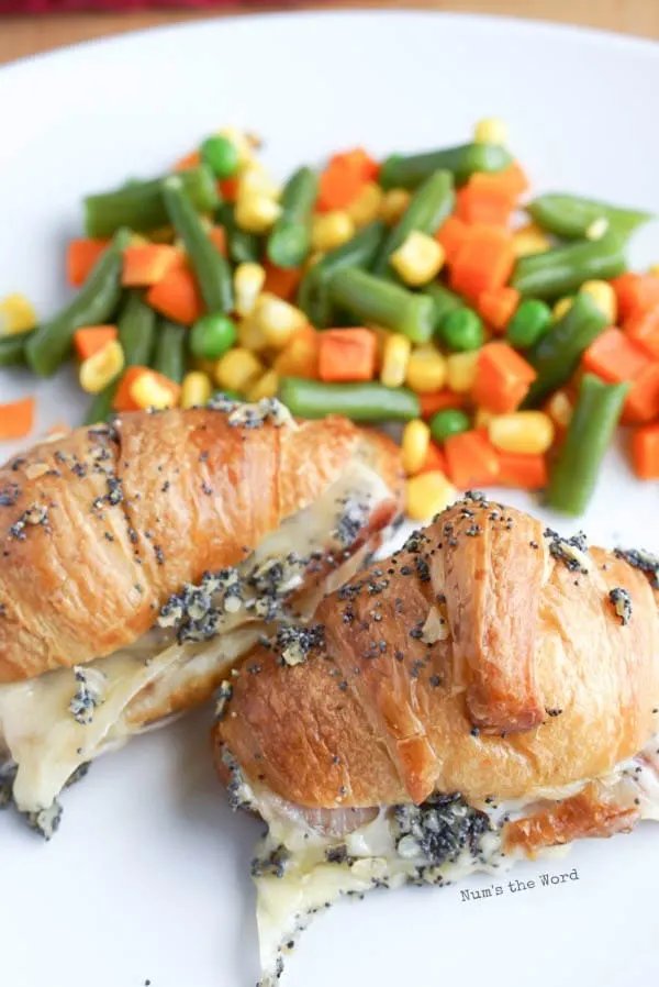 sandwiches on a plate with mixed veggies in the background