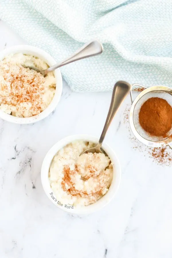 Rice Pudding - zoomed out image of two bowls of rice pudding with cinnamon on top