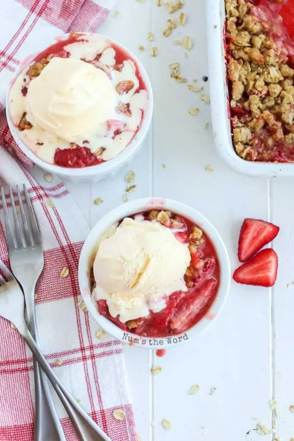 Strawberry Crisp Recipe - top view of two strawberry crisps in a bowl with scoops of ice cream
