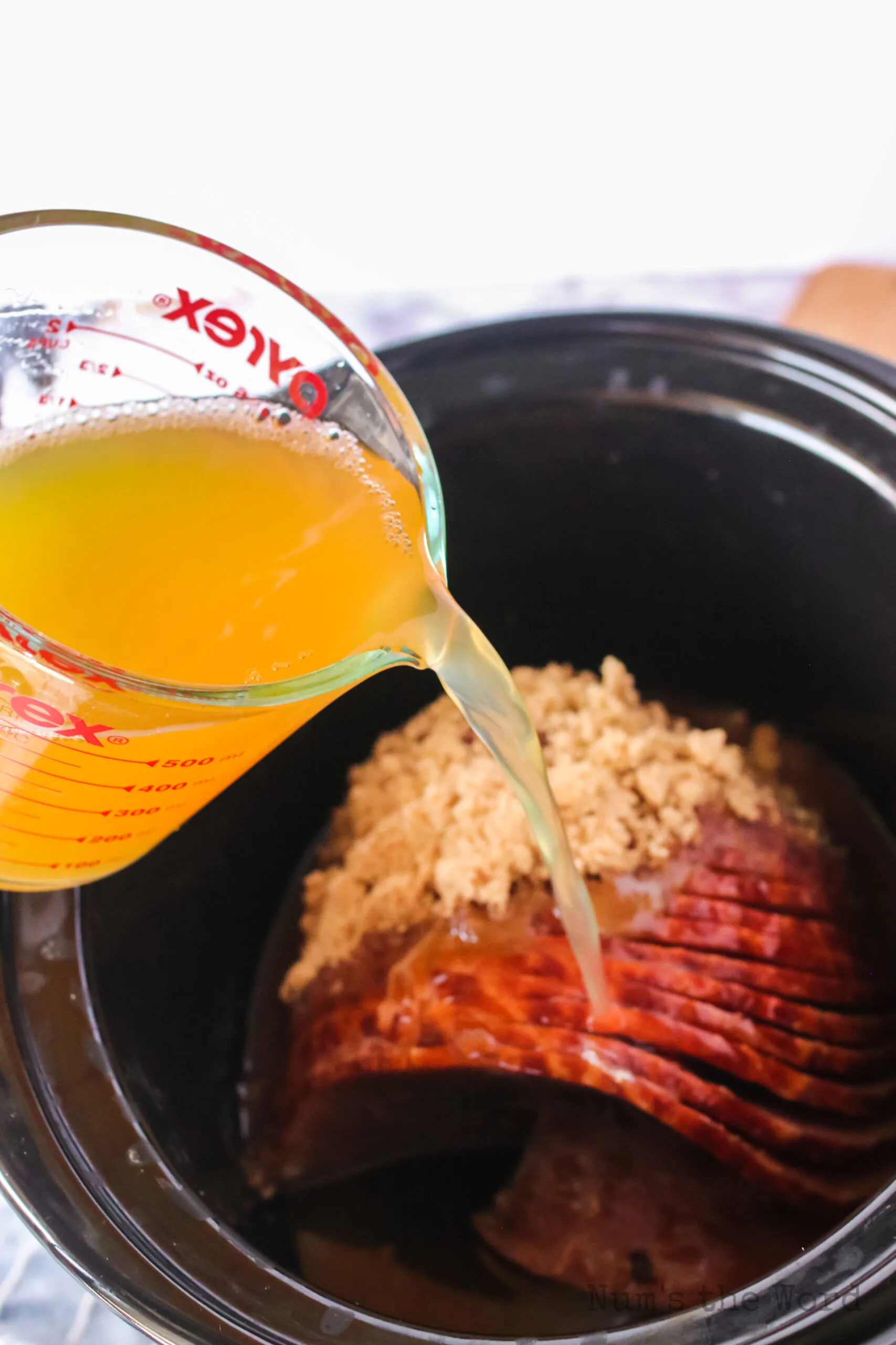 pineapple juice poured over brown sugar ham