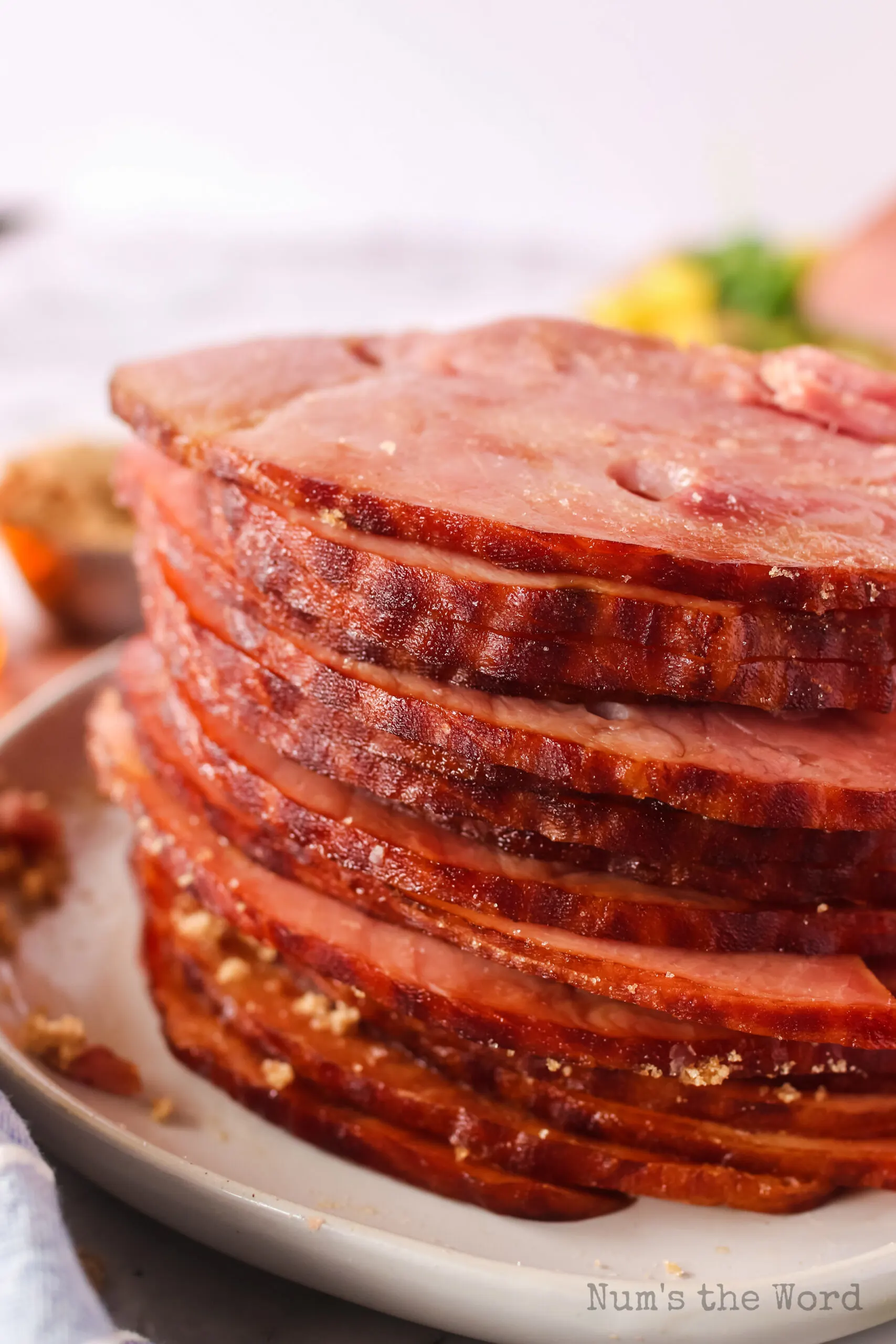 sliced ham stacked upon a platter