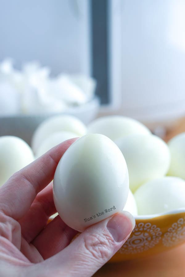 Air Fryer Hard Boiled Eggs - hand holding an egg close to camera to show perfect peel
