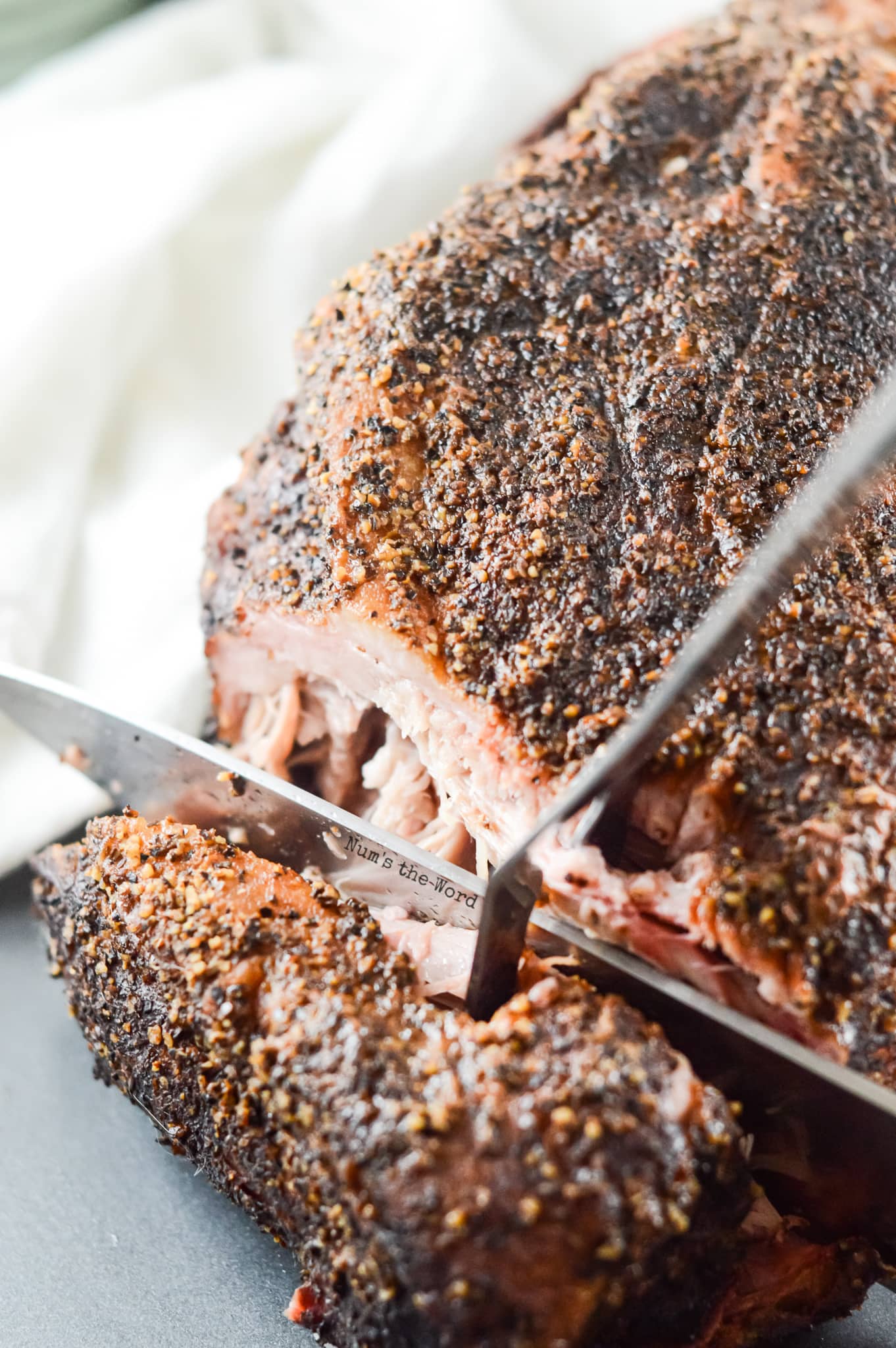 Smoked Pork Shoulder - pork shoulder cooked and sliced open to show how tender the pork is inside.