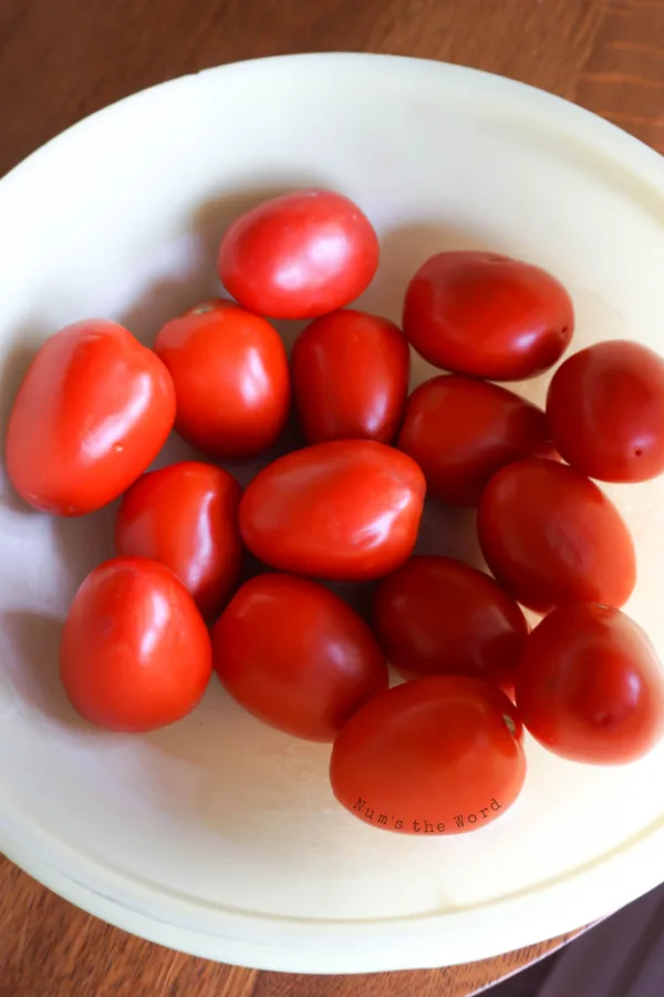 A bowl of fresh grown roma tomatoes