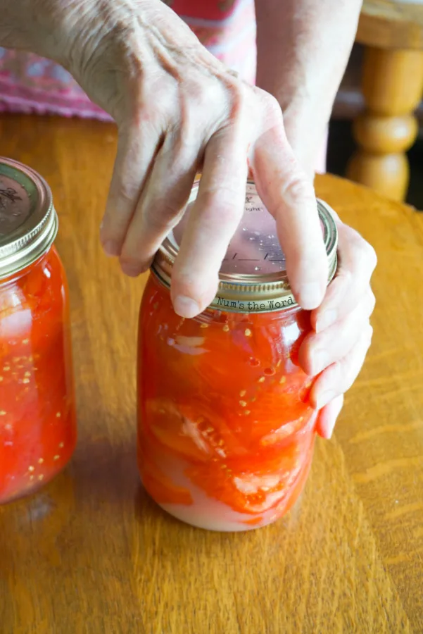 screwing the canning rims to the jars