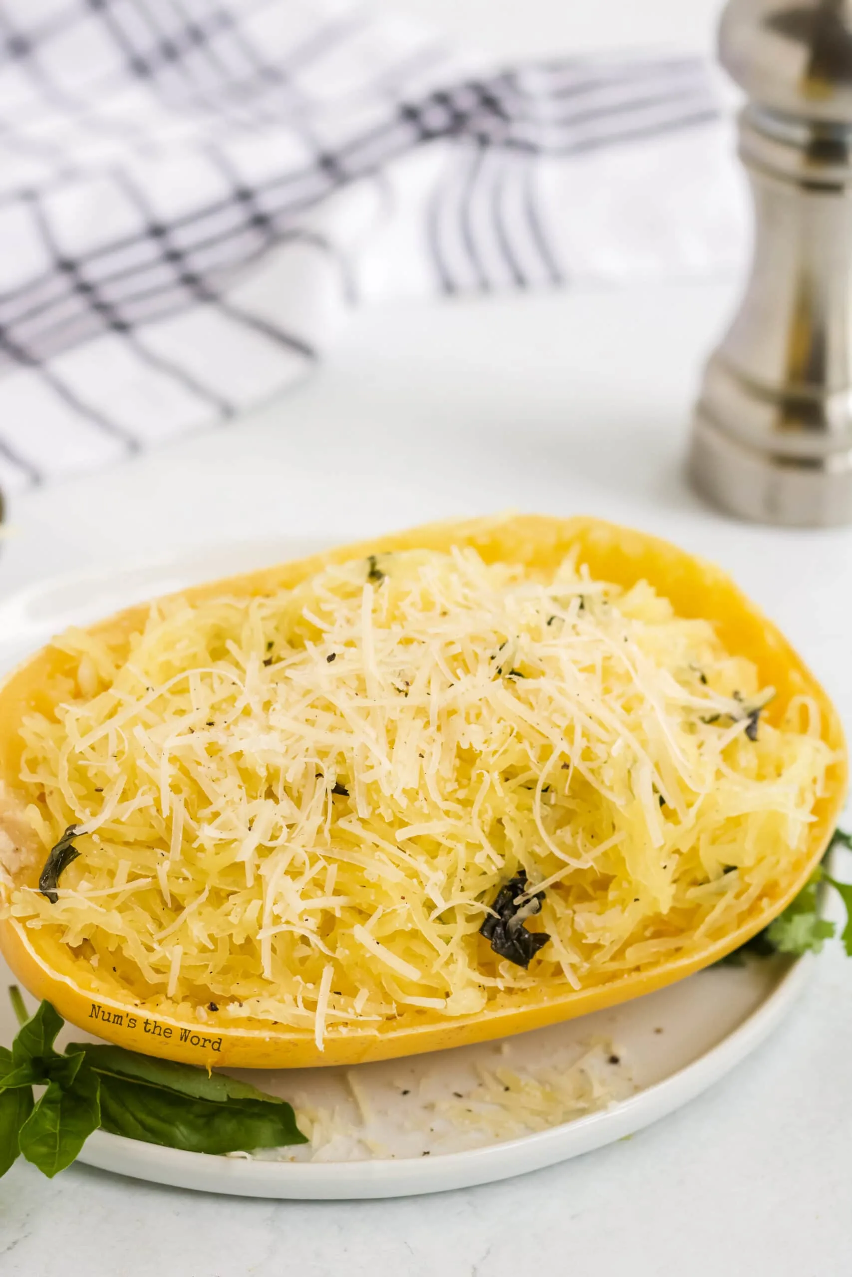 cooked squash strands placed back into spaghetti squash skin and topped with cheese