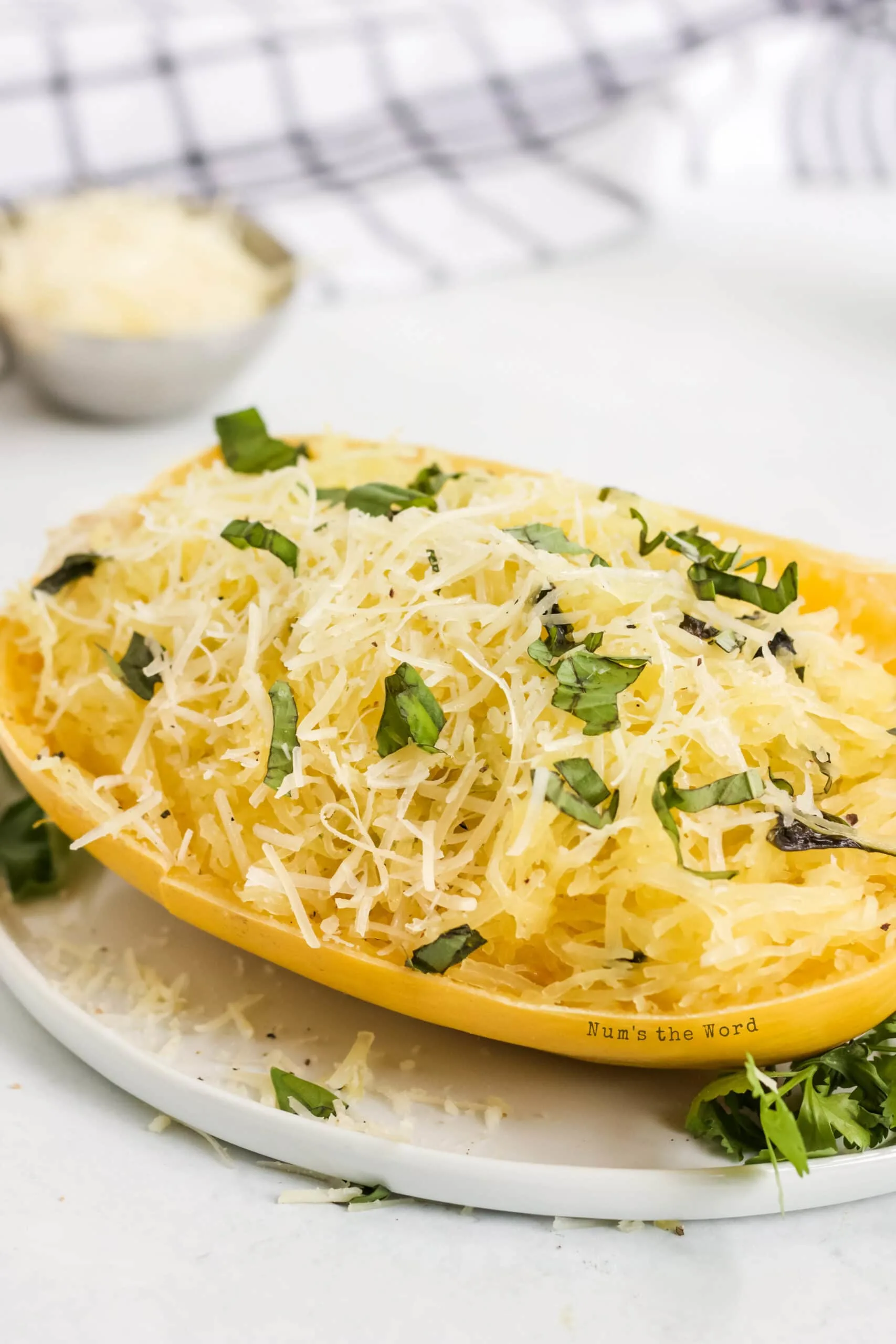 side view of squash ready to be eaten with cheese and basil on top