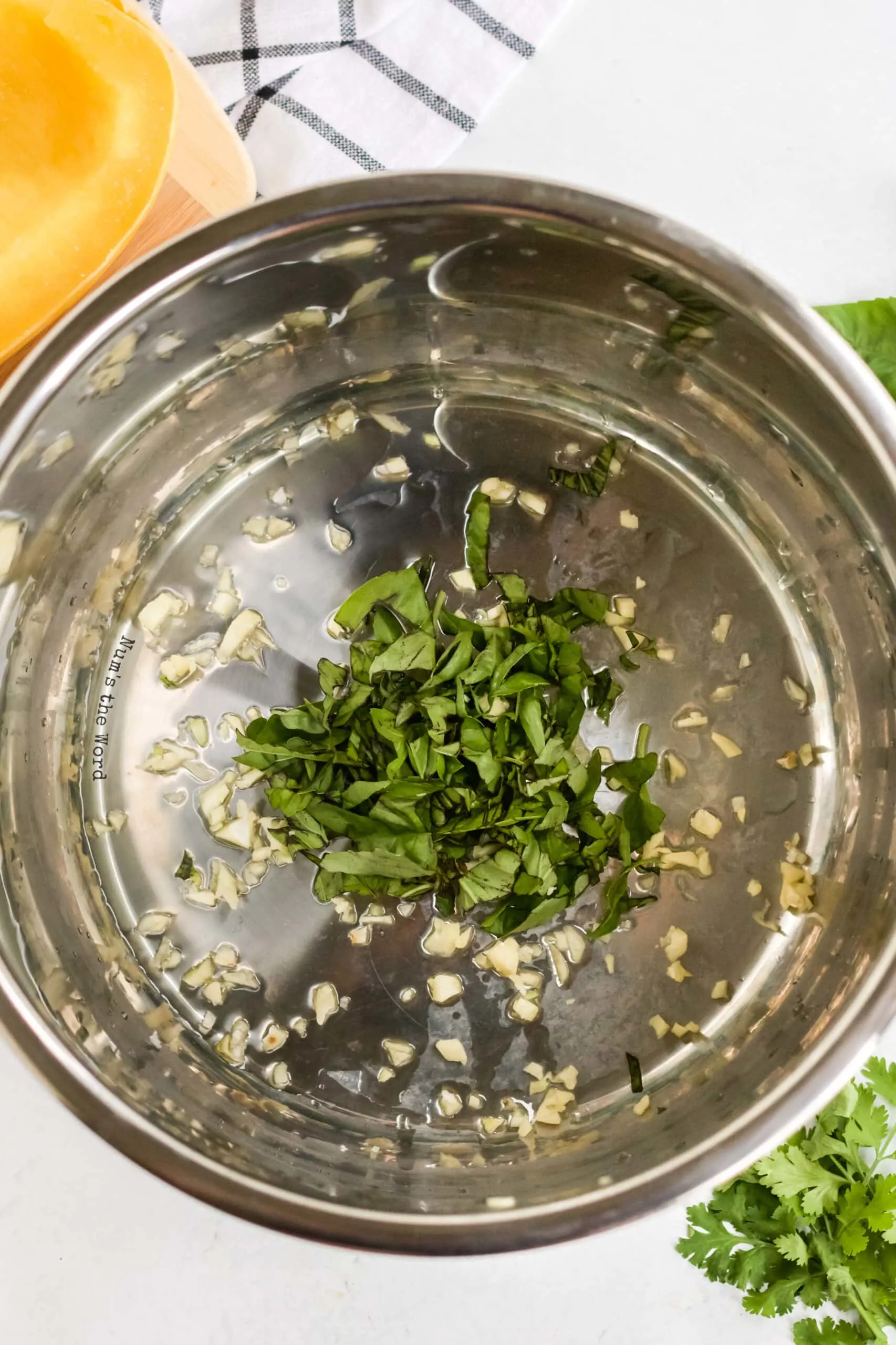 oil, basil and garlic in instant pot ready to saute