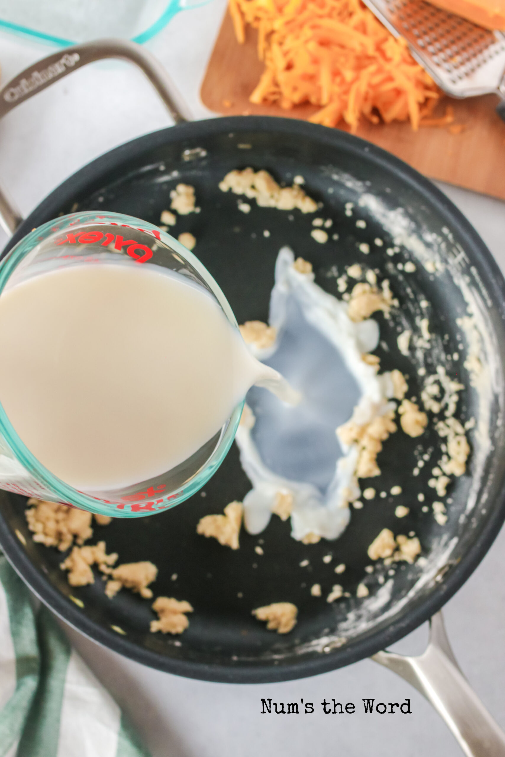 butter and flour mixed together. Milk being added to pan.