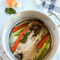 vegetables added to turkey bones in large pot