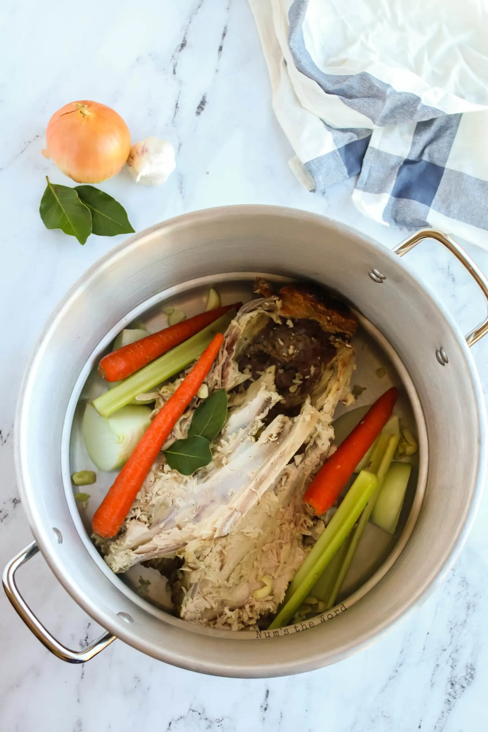 vegetables added to turkey bones in large pot