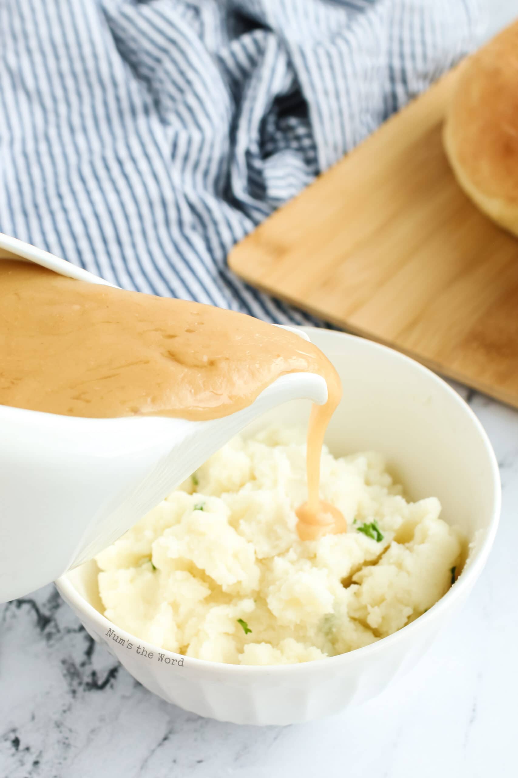 gravy being poured over mashed potatoes