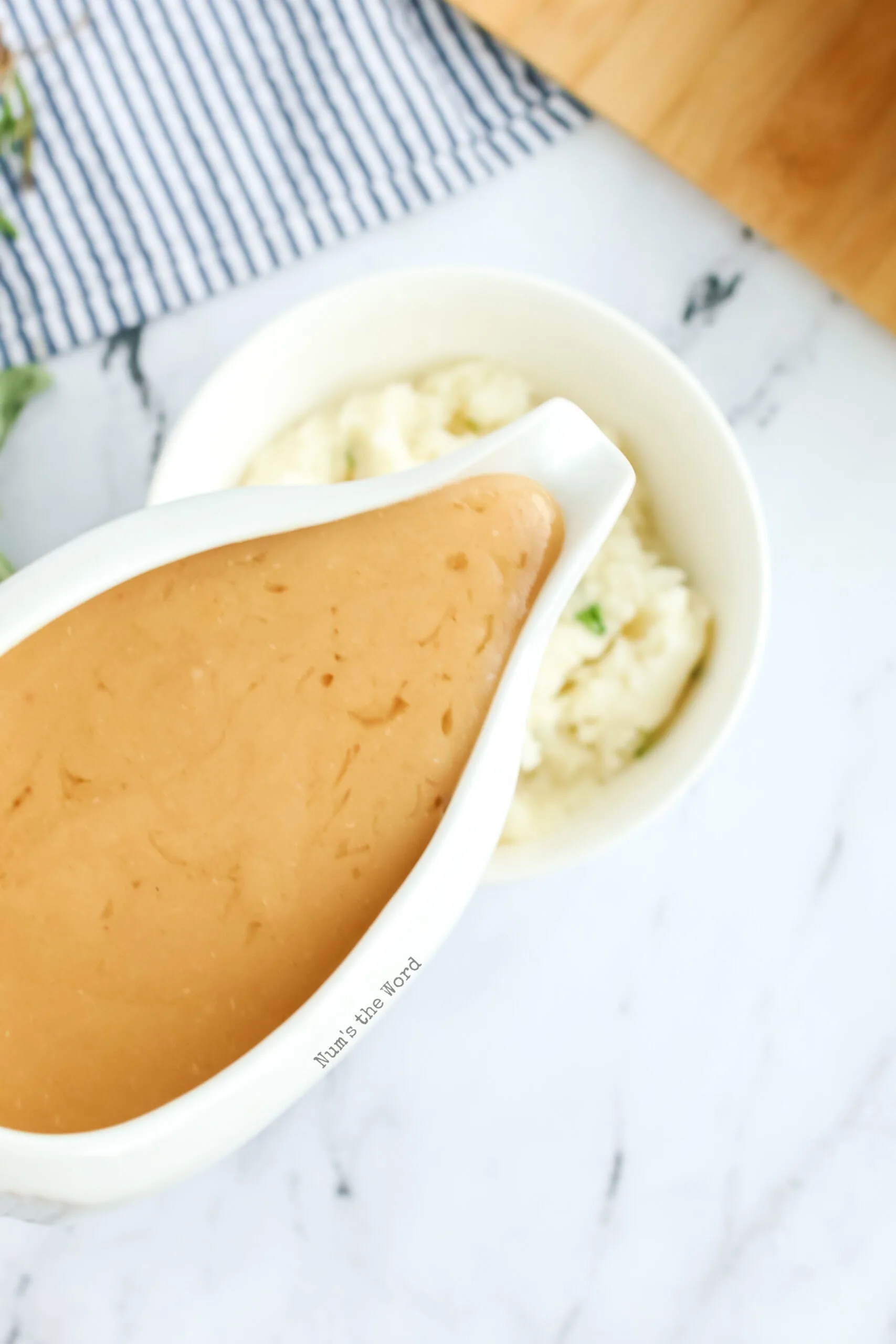 close up image of gravy in gravy boat ready to be poured over mashed potatoes