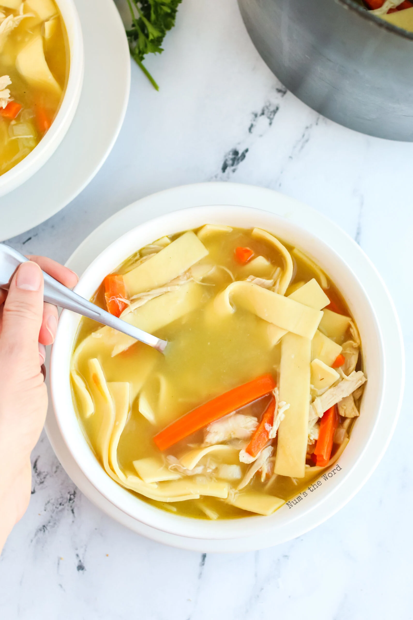 zoomed out image of bowl of soup with a spoon in it