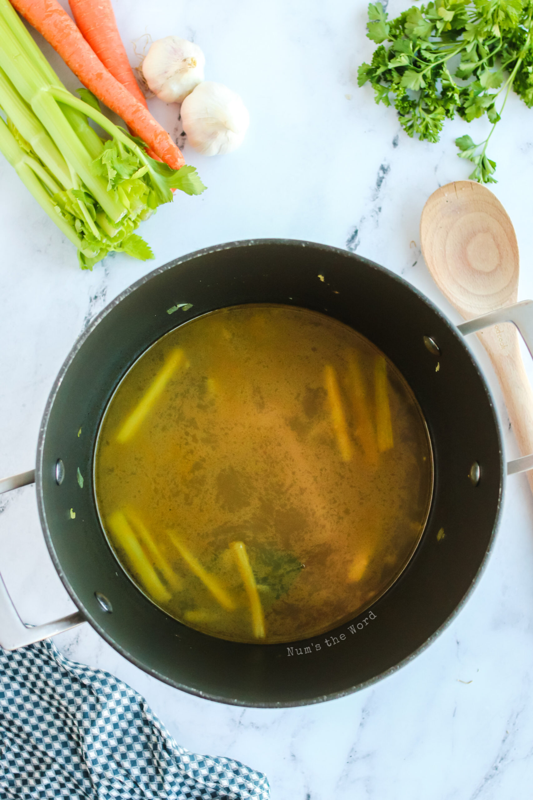 broth added to sautéed vegetables in pot