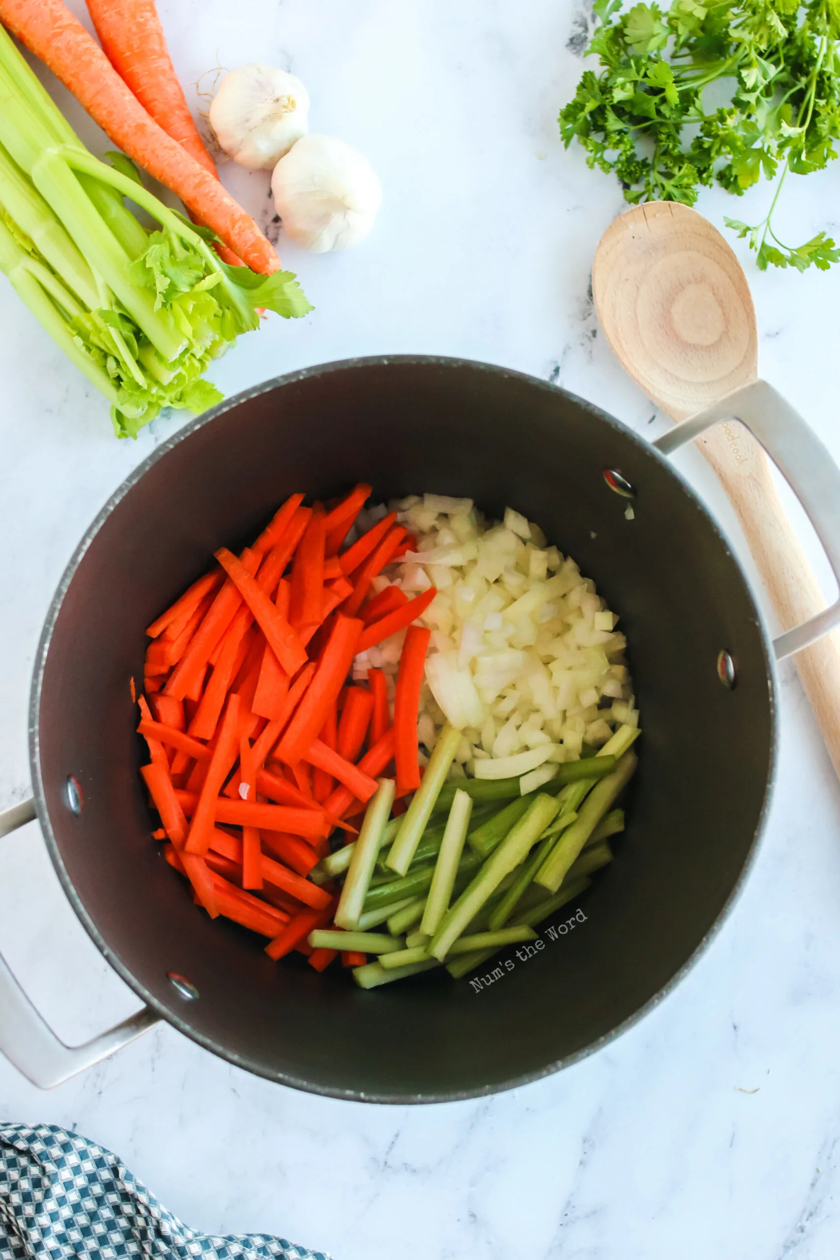 vegetables all cut up and placed in a pot.