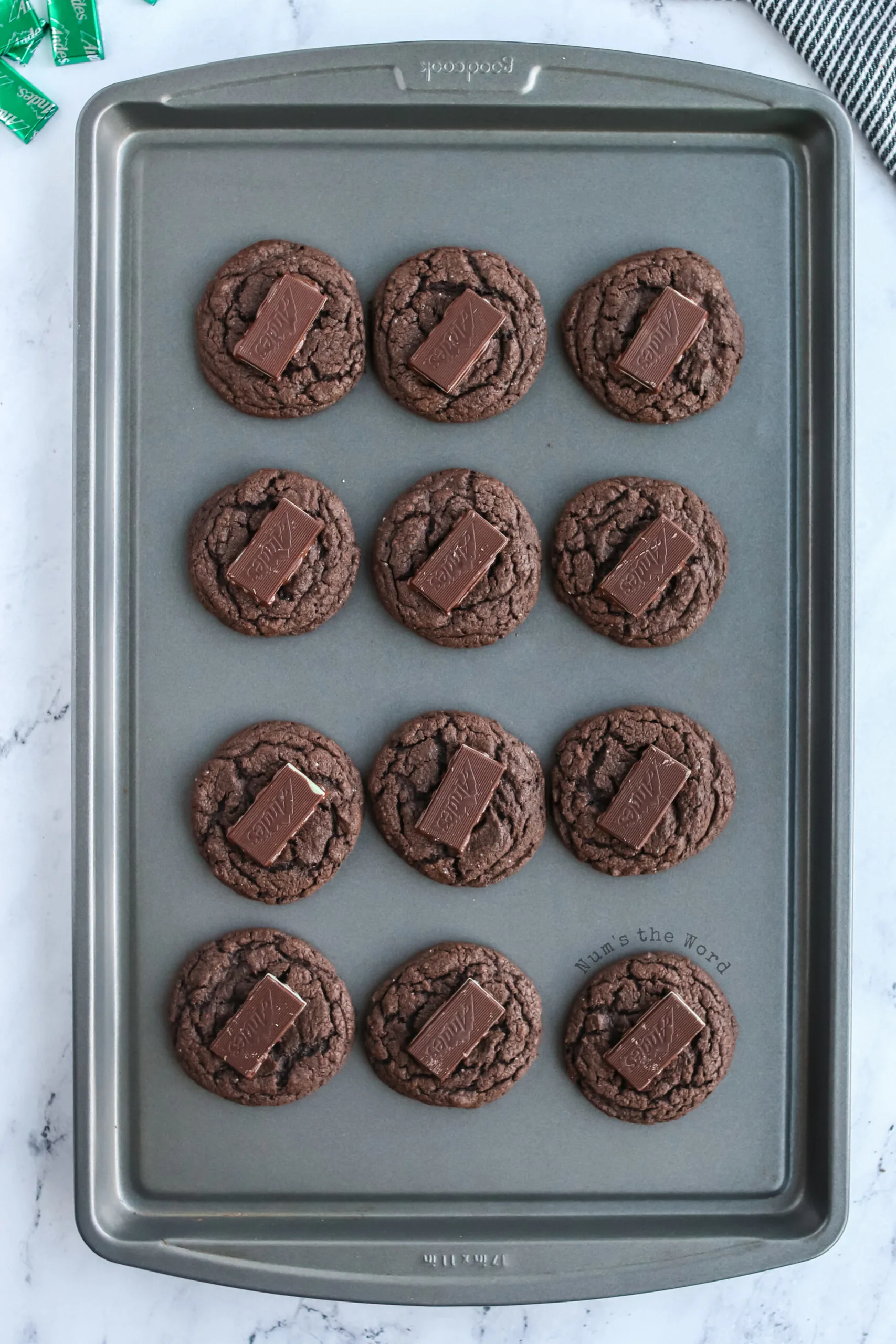 An Andes mint placed on top of each hot cookie.