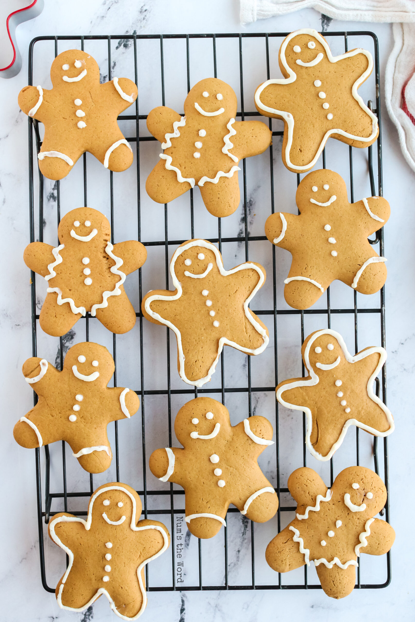 baked and decorated cookies on a cooling rack, view from on top