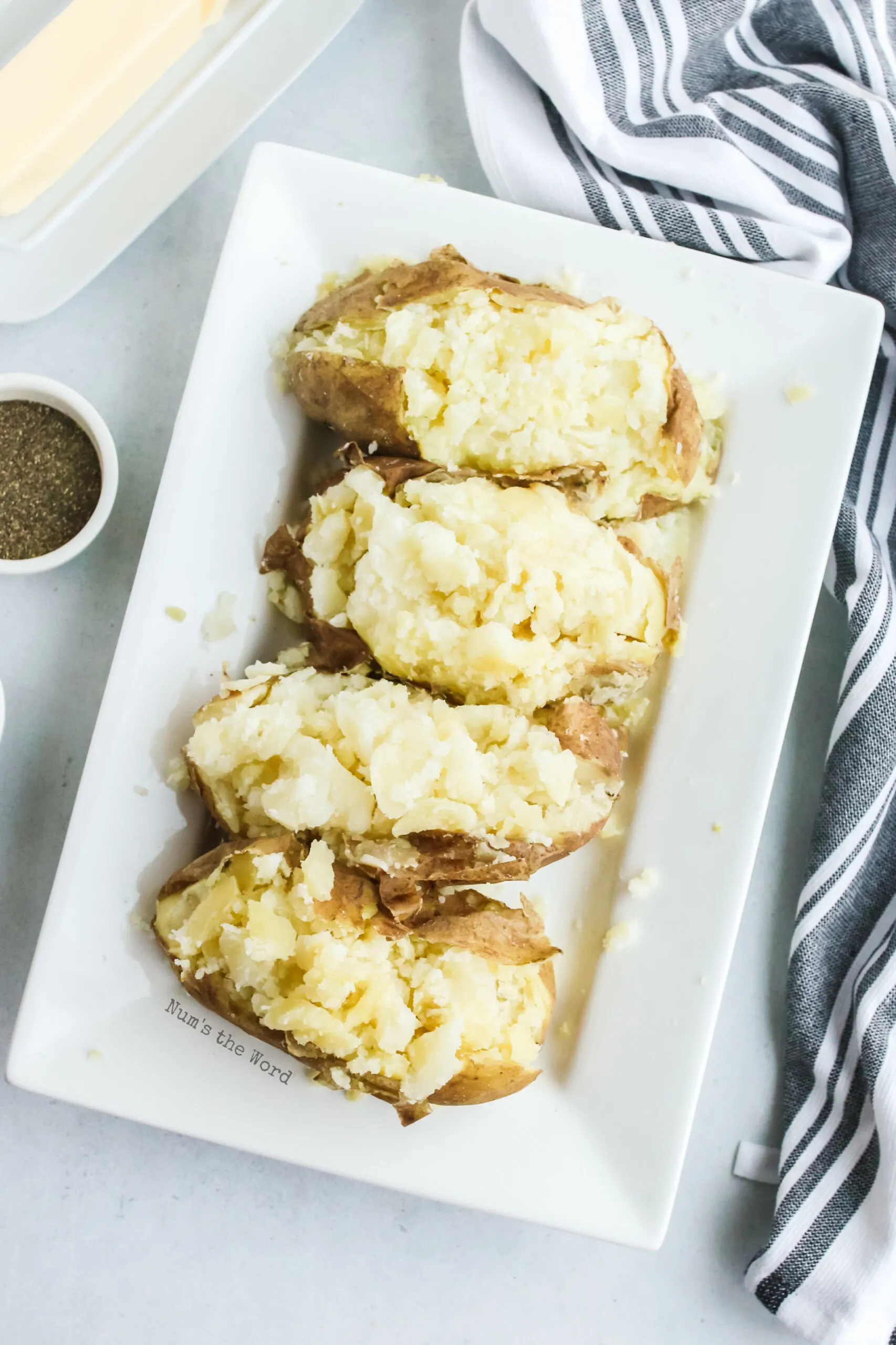 4 baked potatoes, cut in half with insides fluffed and ready to be eaten