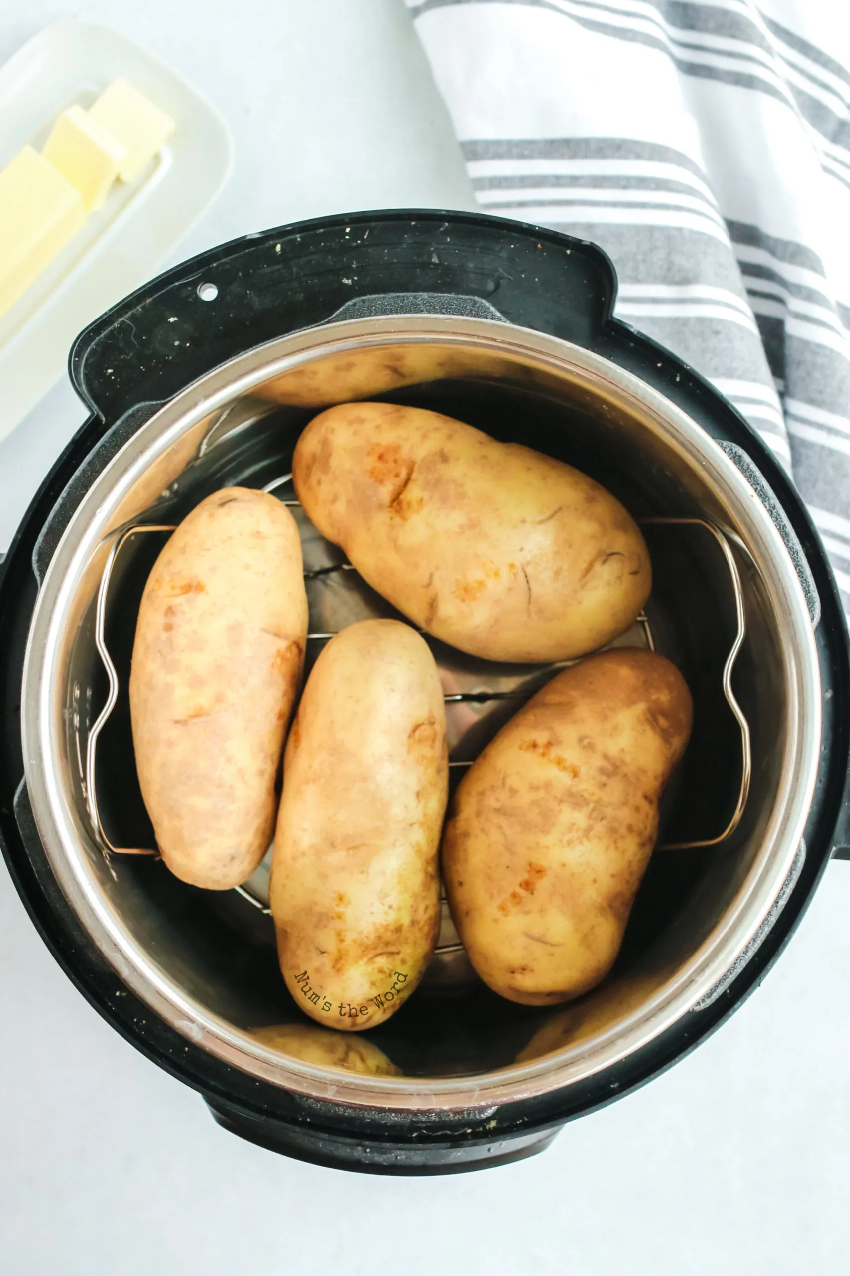 4 unbaked potatoes placed into an instant pot