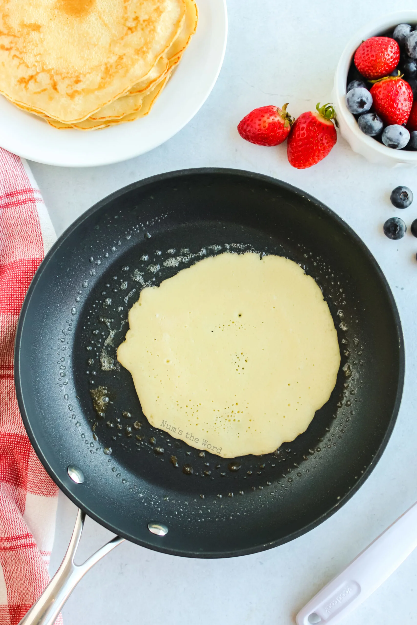 crepes batter poured into a buttered skillet