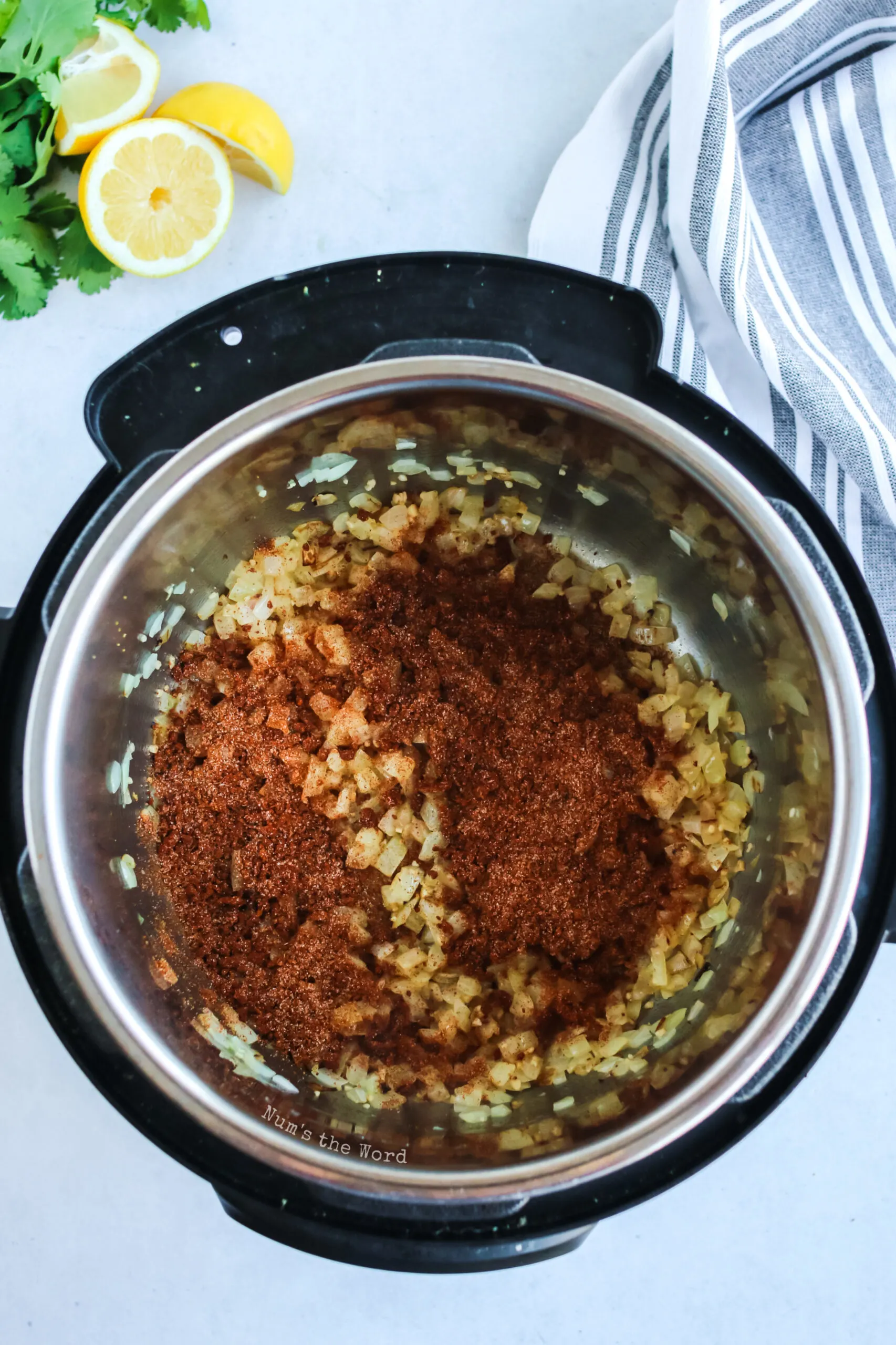 Mixed seasoning added to onions and garlic in the instant pot