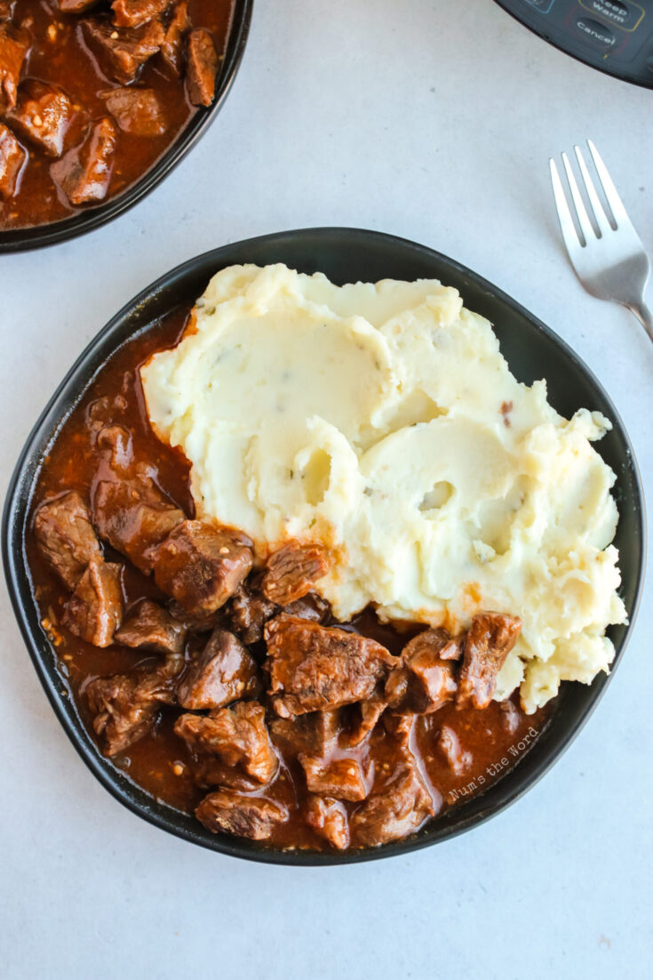 close up of plate with mashed potatoes and beef paprikash.