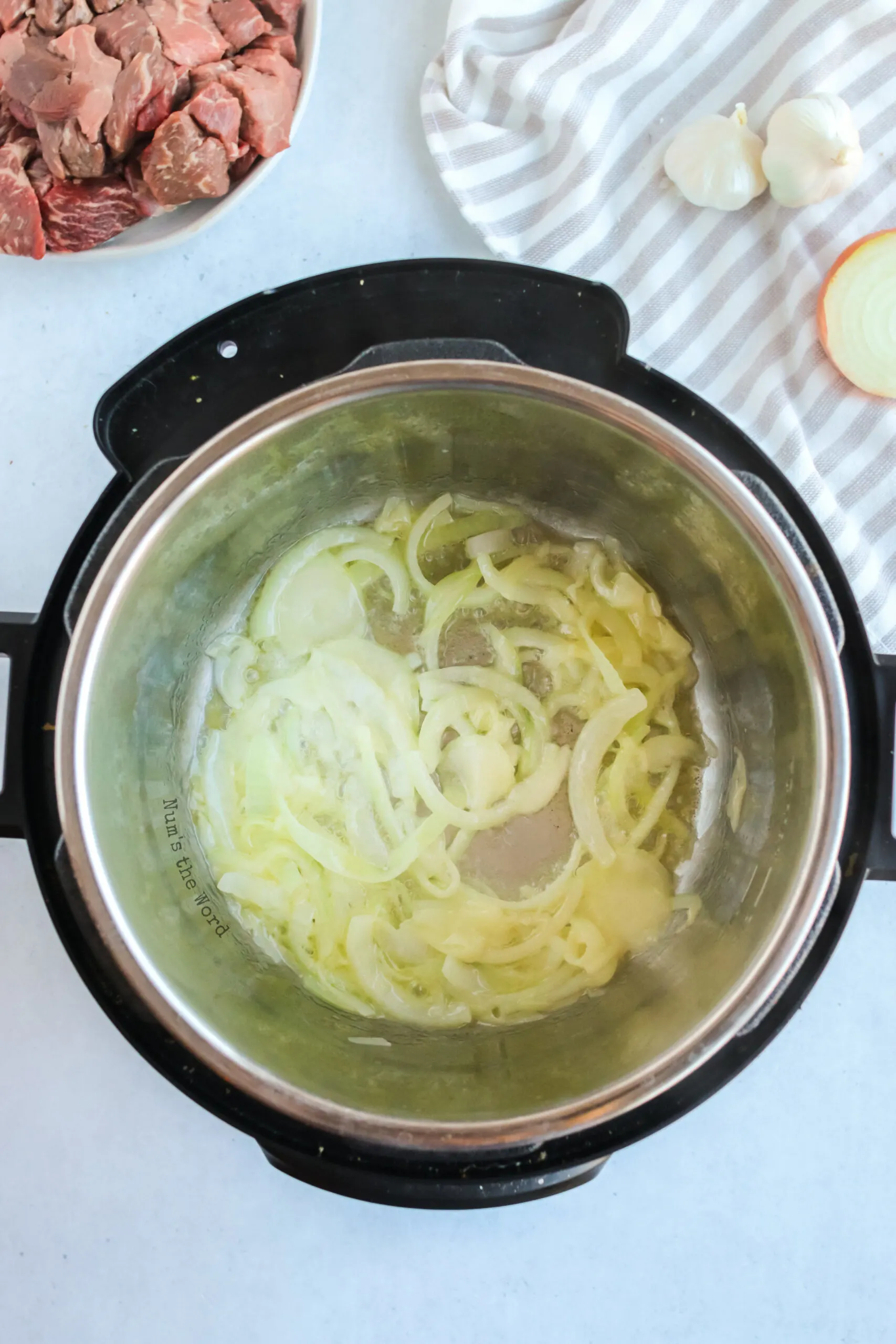 onions being sautéed in the instant pot. 