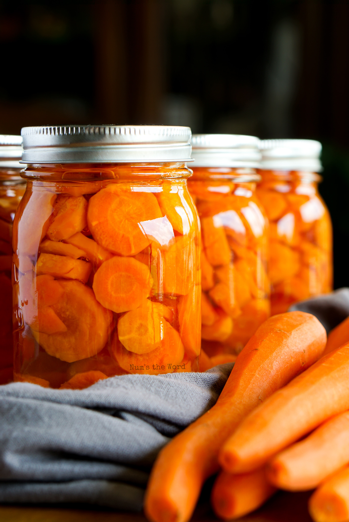 Side view of canned carrots and fresh carrots