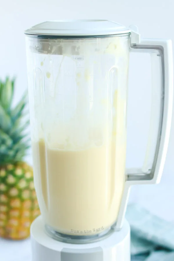 ice cream, pineapple and pineapple juice in blender, mixed up