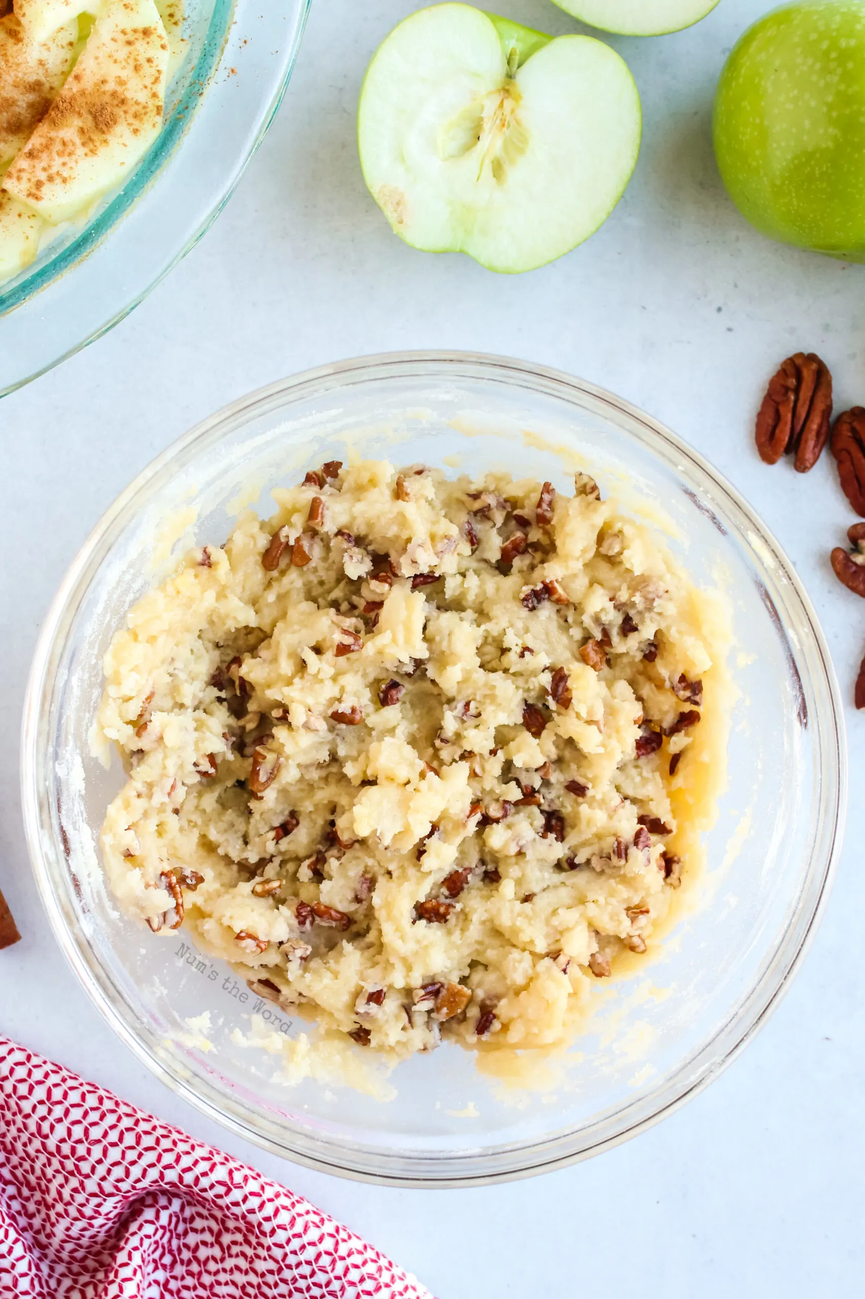 Pie crust mixed in a bowl and ready to spread on top of apple slices.