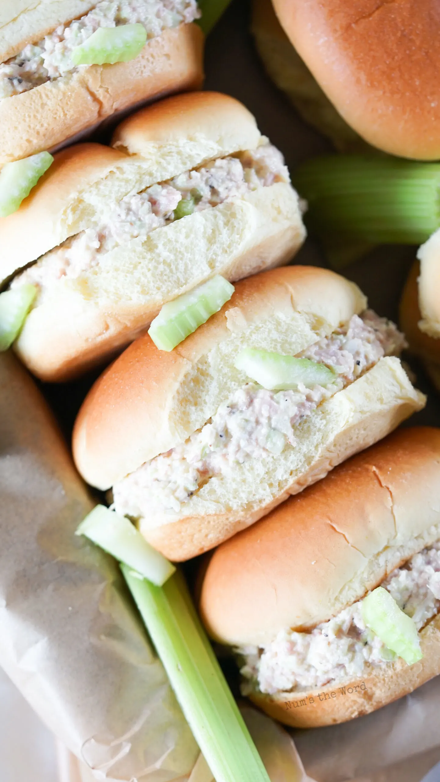 3 sandwiches in a basket at an angle.