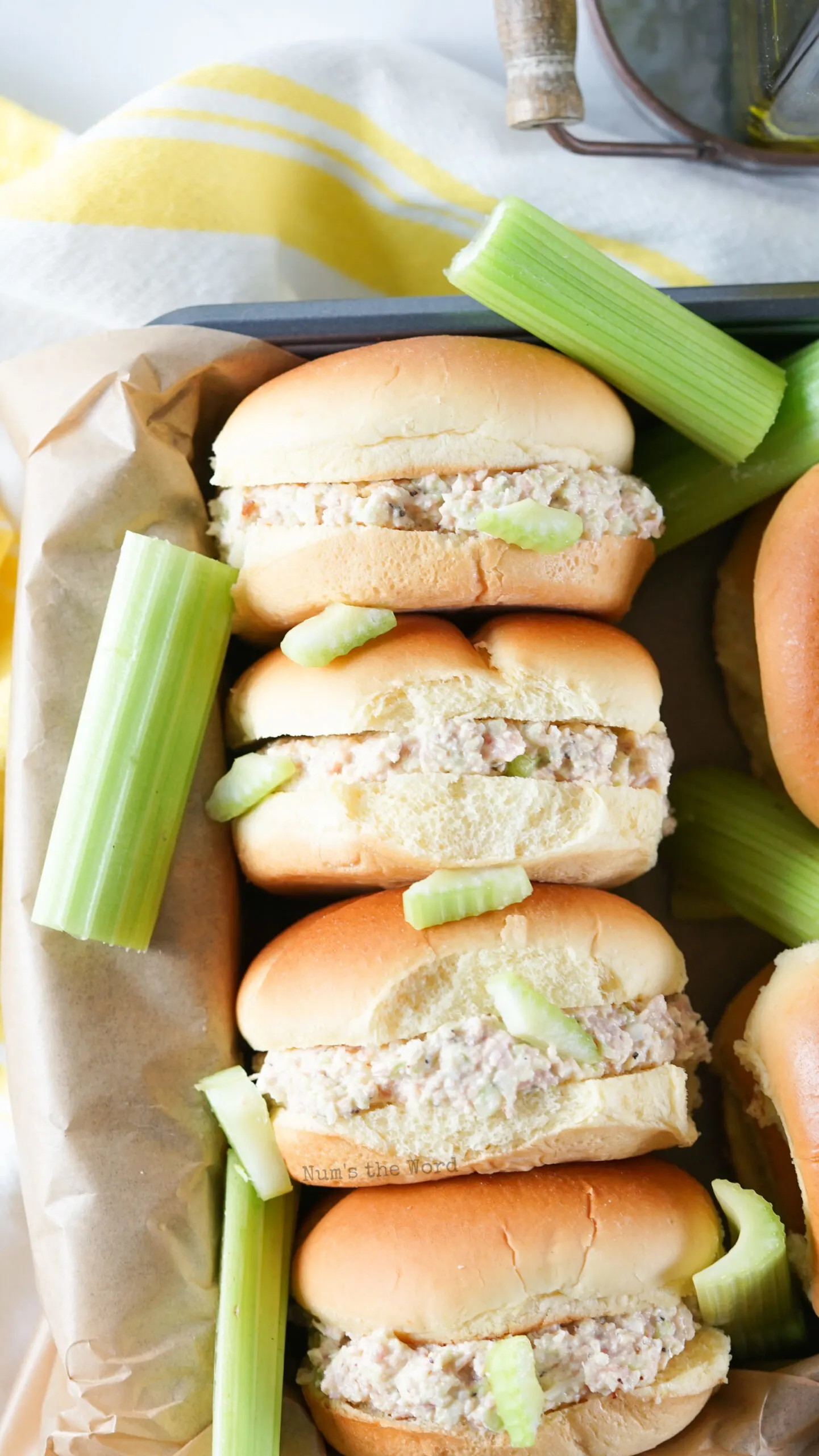 4 sandwiches lined up in a basket