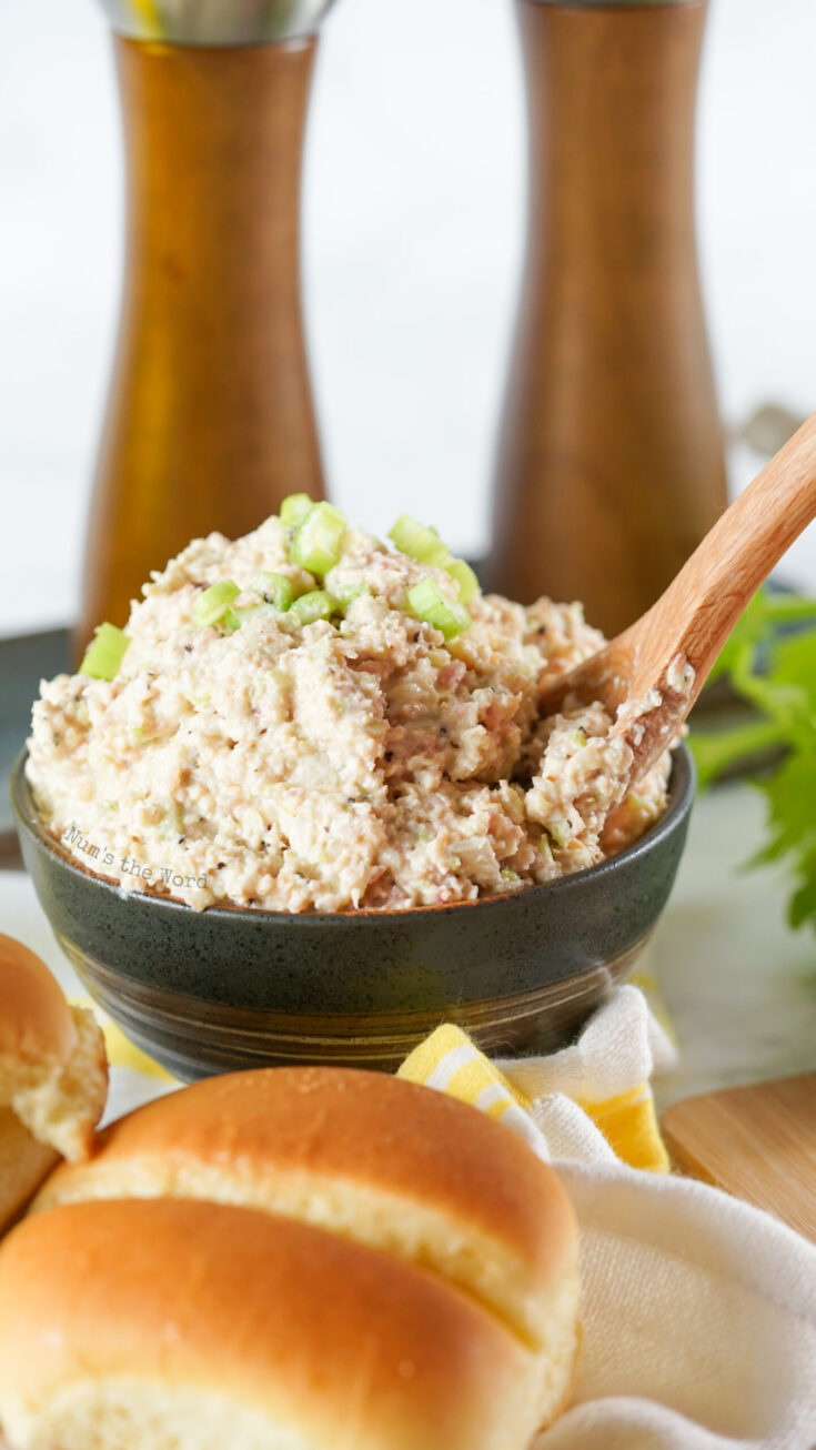 ham salad in a bowl with a wooden spoon in it