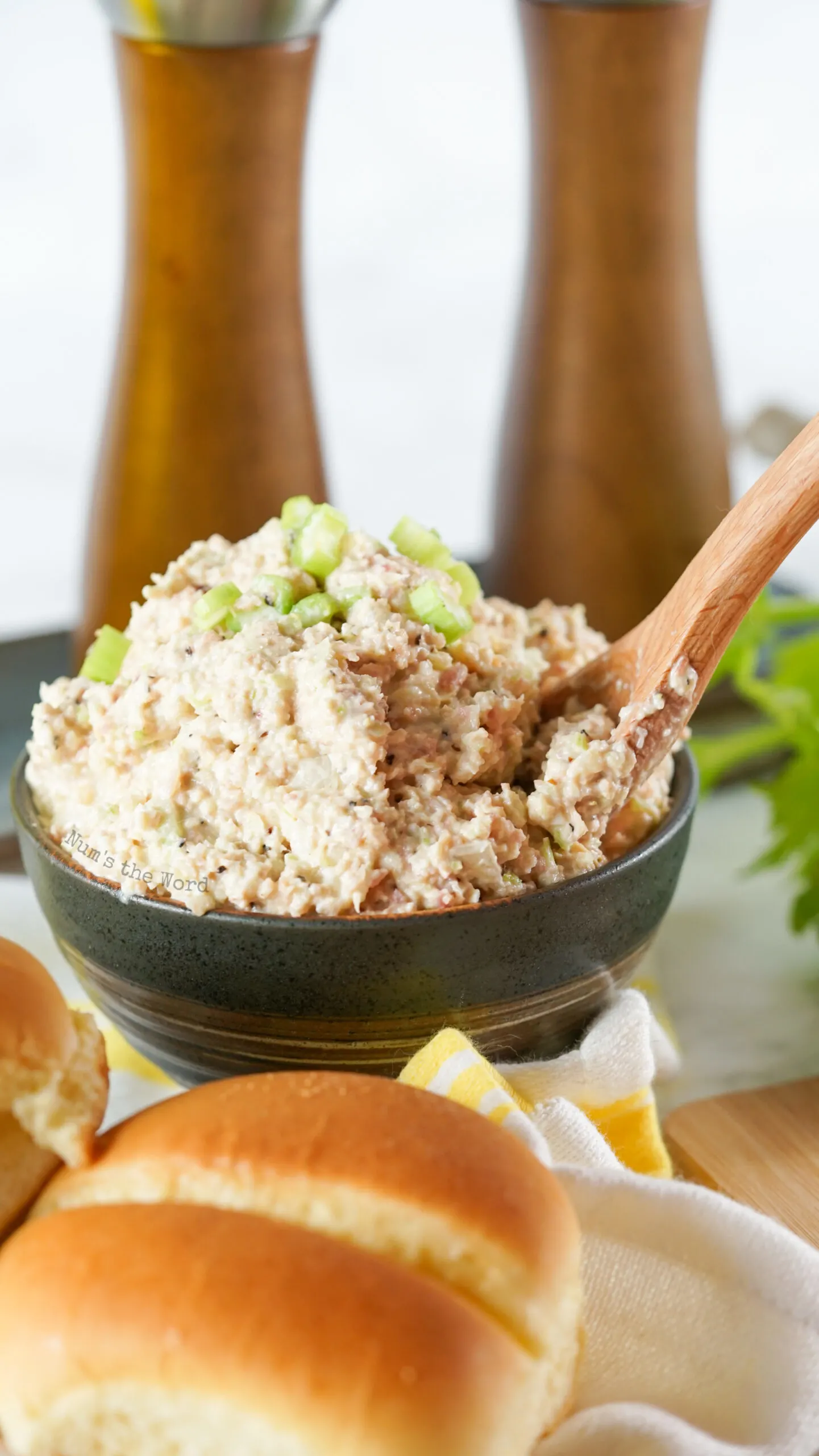 ham salad in a bowl with a wooden spoon in it