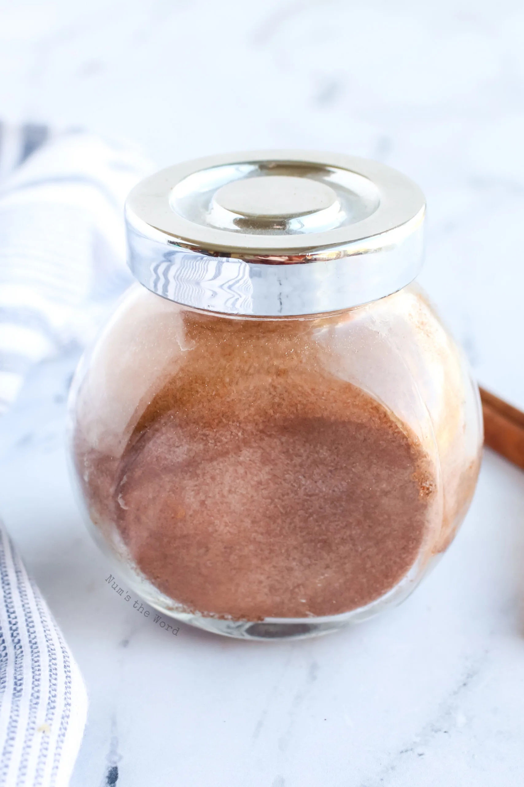 jar of cinnamon sugar with lid on, top side view