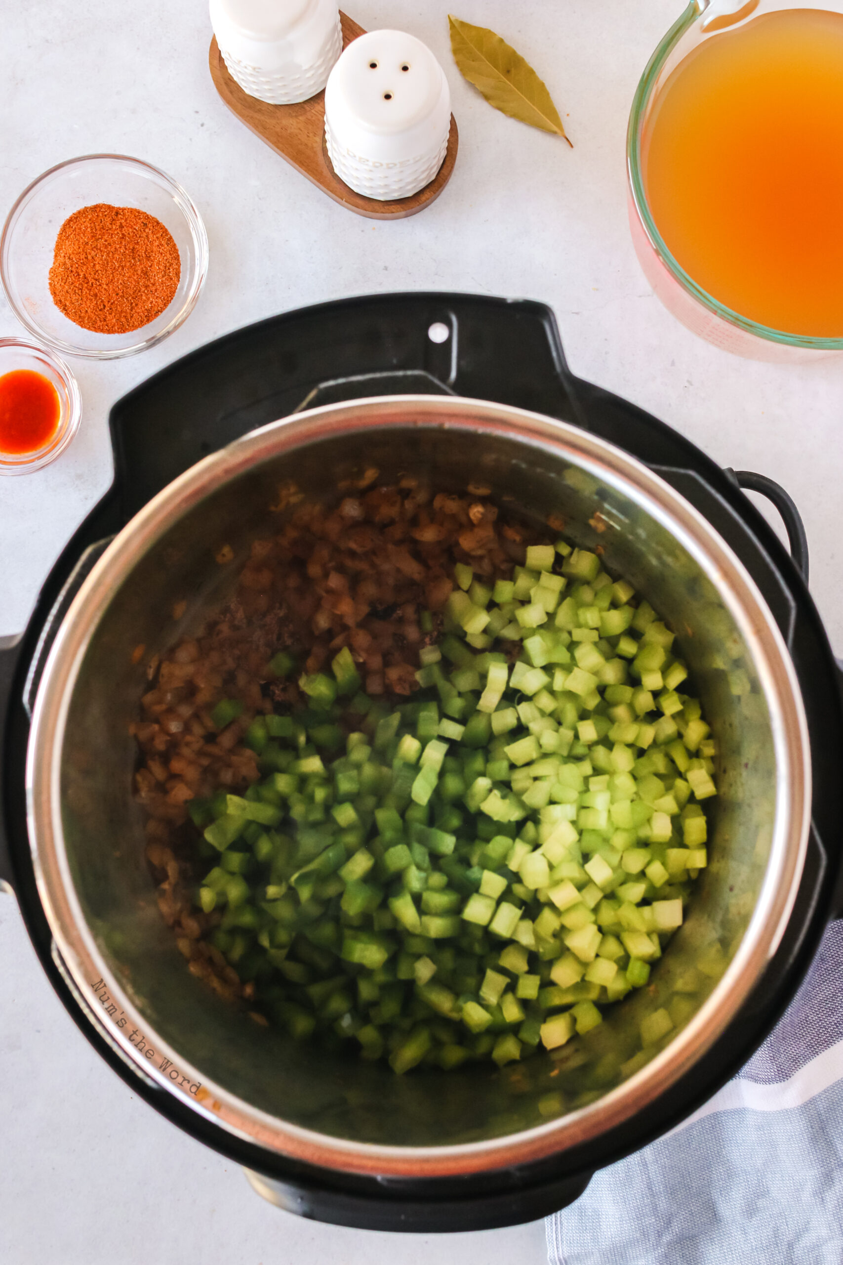 Bell peppers and celery added to onions and garlic in instant pot