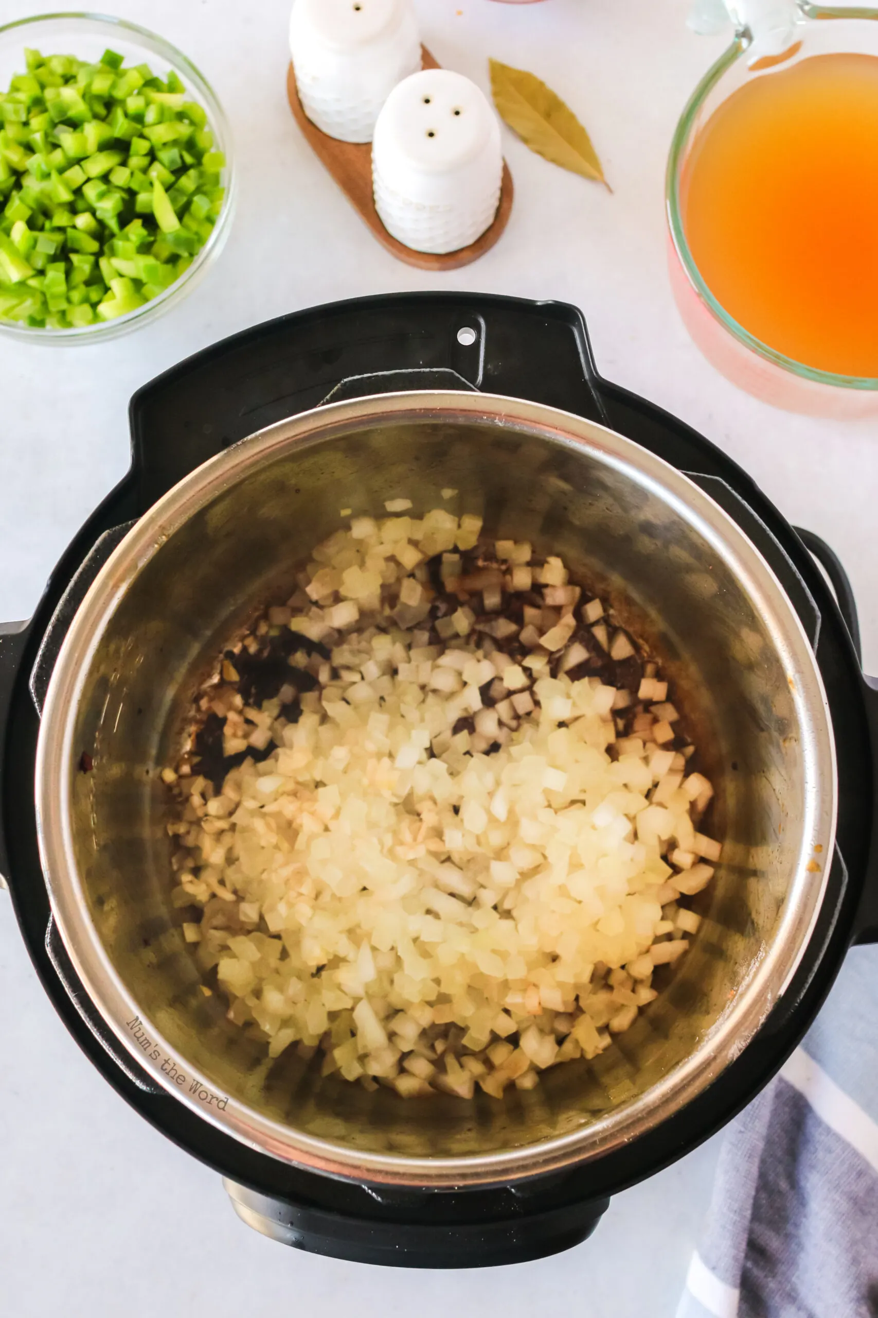 Onion and garlic in instant pot ready to be cooked.