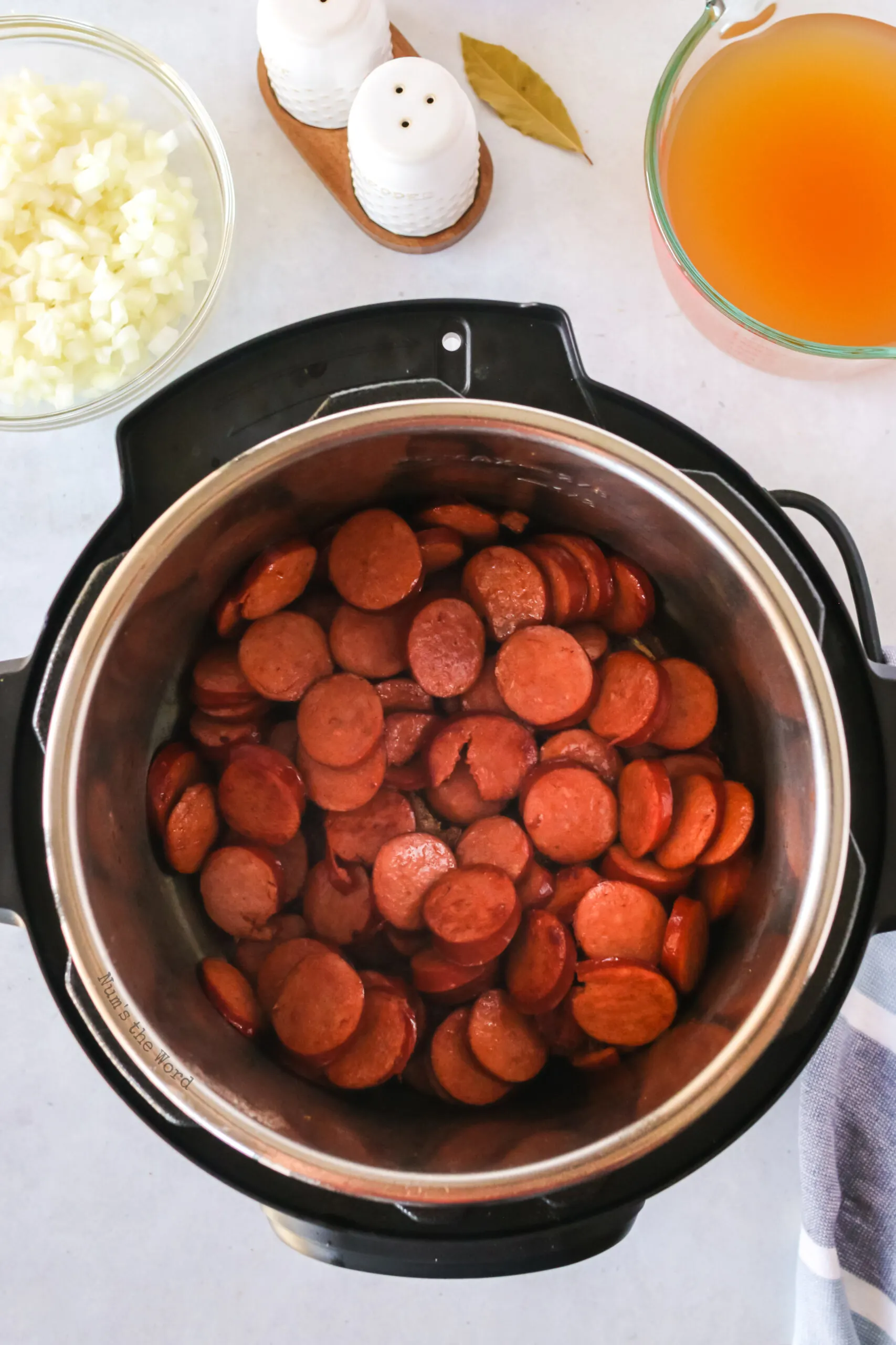 Sausage being seared in instant pot until browned.