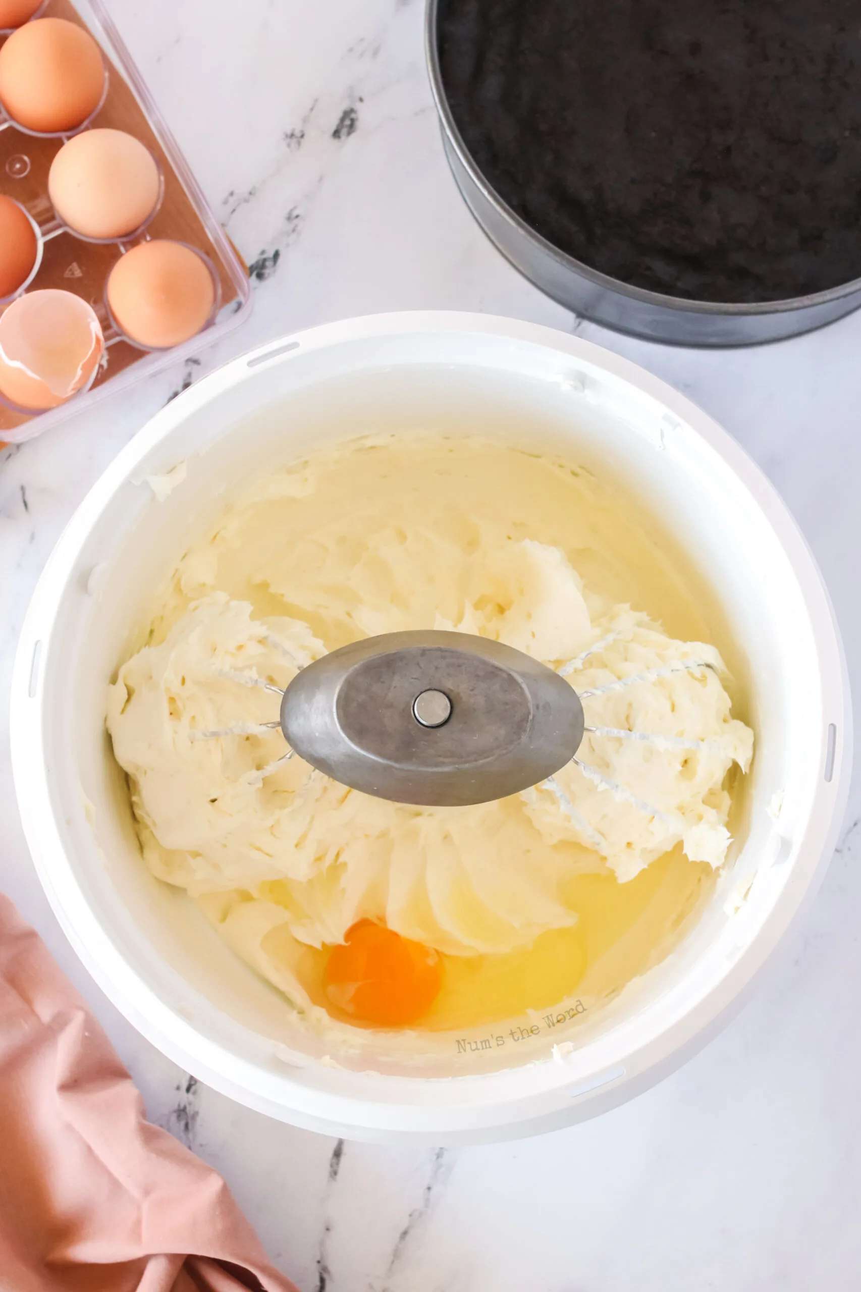 eggs and egg yolks added to mixing bowl one at a time