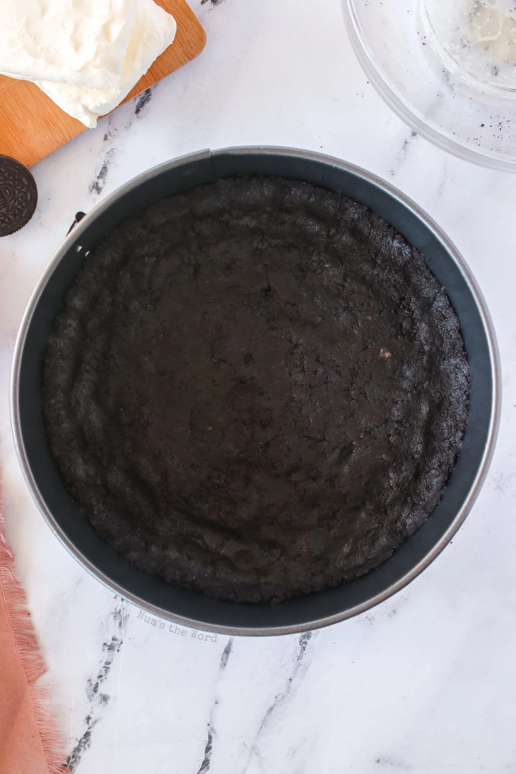 oreo crust added to cheesecake pan and pressed into place.