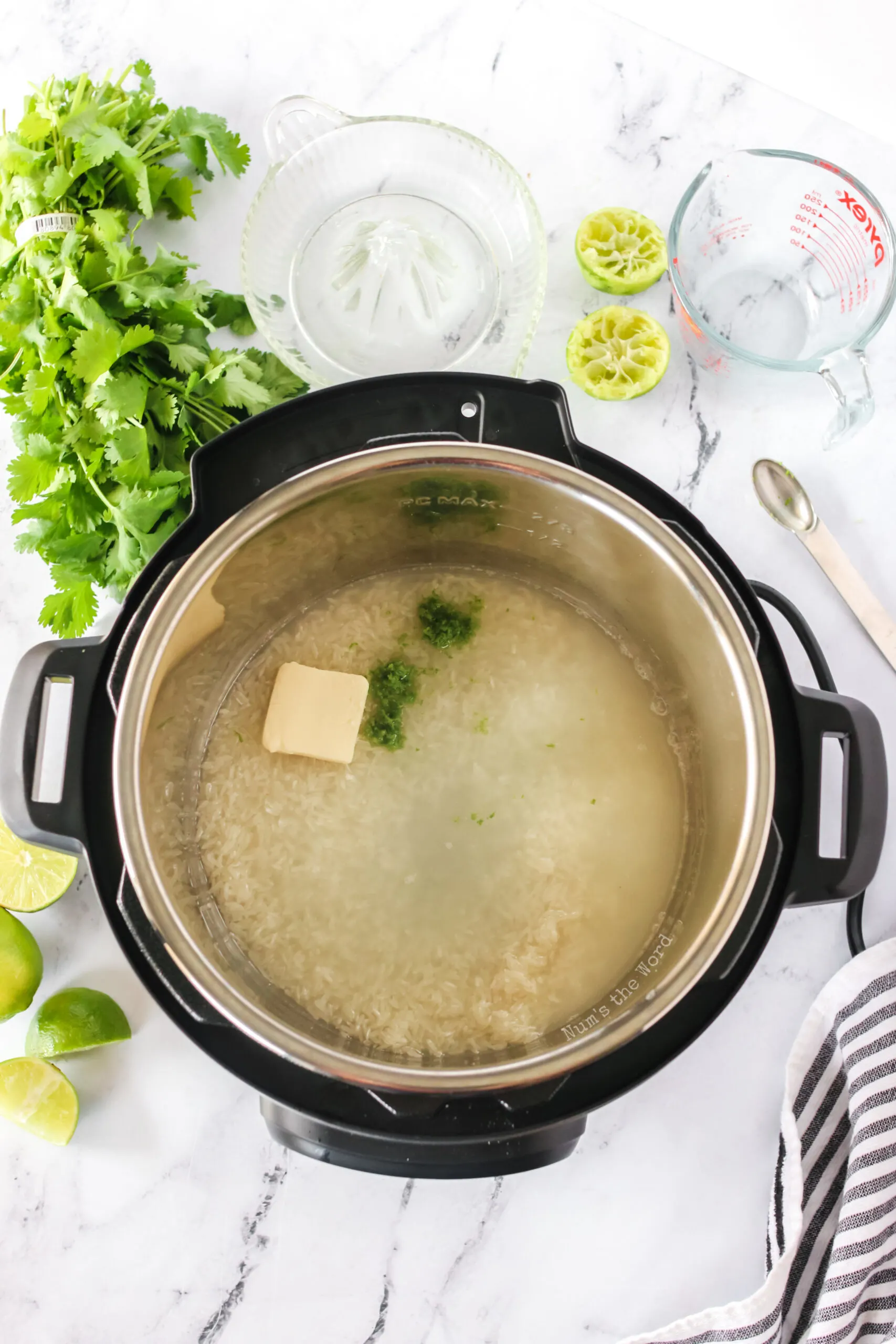 rinsed rice, butter, lime zest, lime juice and water all added to instant pot.