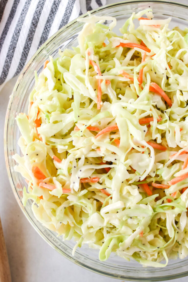 Zoomed in image taken from the top looking down of ready coleslaw in a glass bowl.