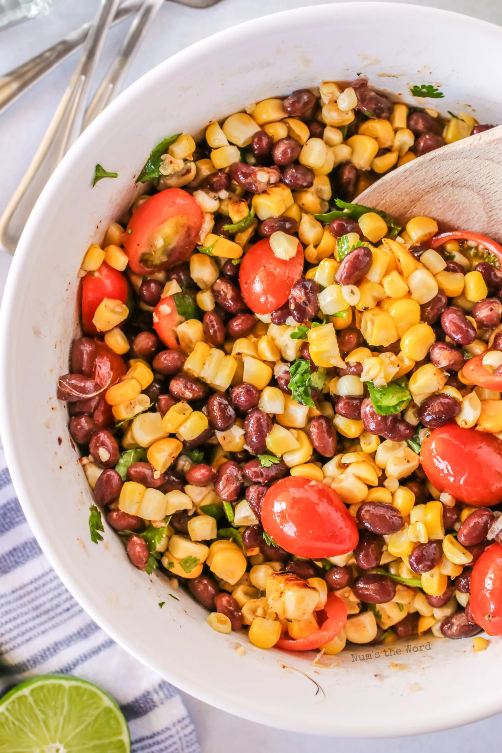 grilled corn salad with dressing in bowl, zoomed in photo.