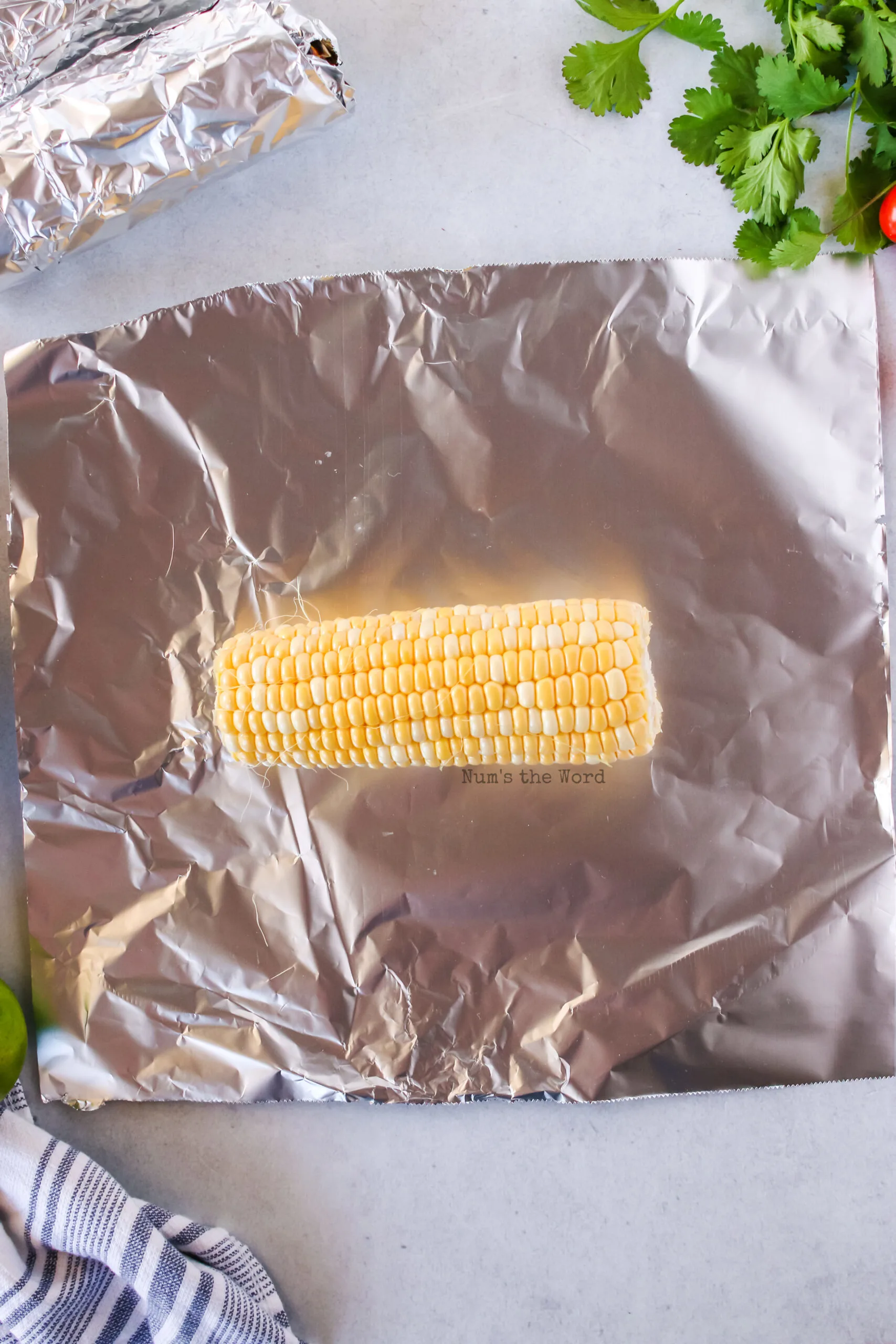 corn cob on top of a piece of foil