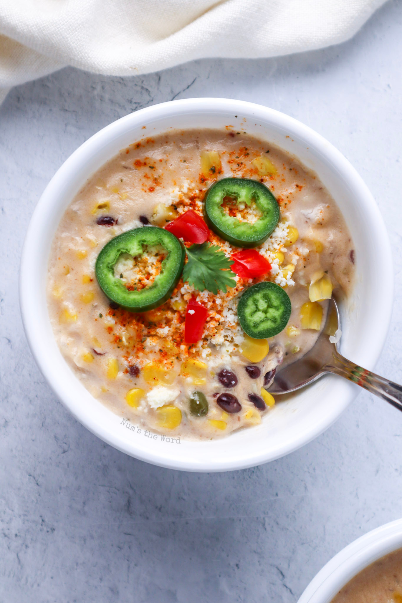 zoomed in image of one bowl of soup with all the toppings, ready to serve.