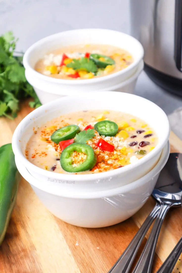 side view of two bowls of soup ready to be eaten.