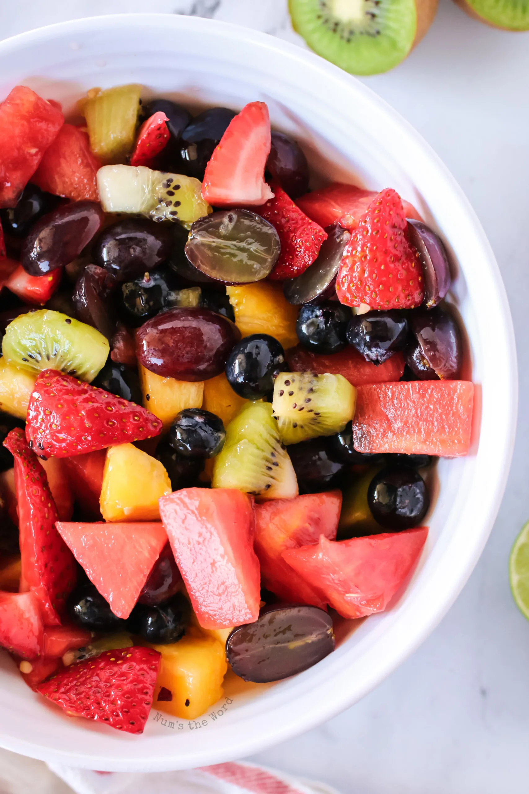 Mixed fruit salad in a bowl close up image.